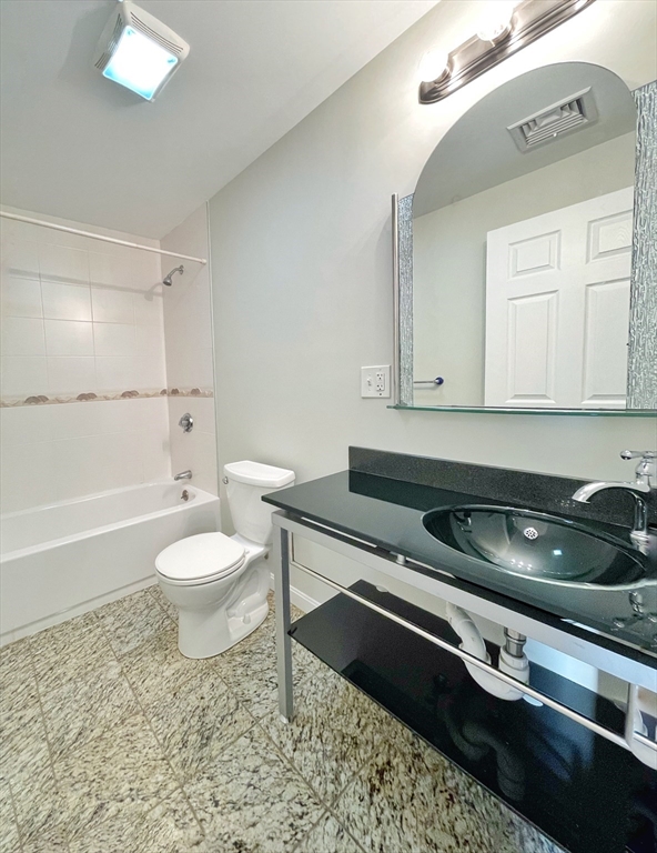 88-90 George Street Boston, MA 02119 - Photo 6 of 15 a bathroom with a sink a toilet and bathtub