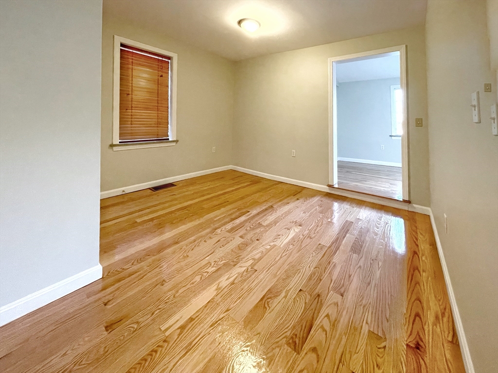 88-90 George Street Boston, MA 02119 - Photo 8 of 15 a view of an empty room with wooden floor and a window