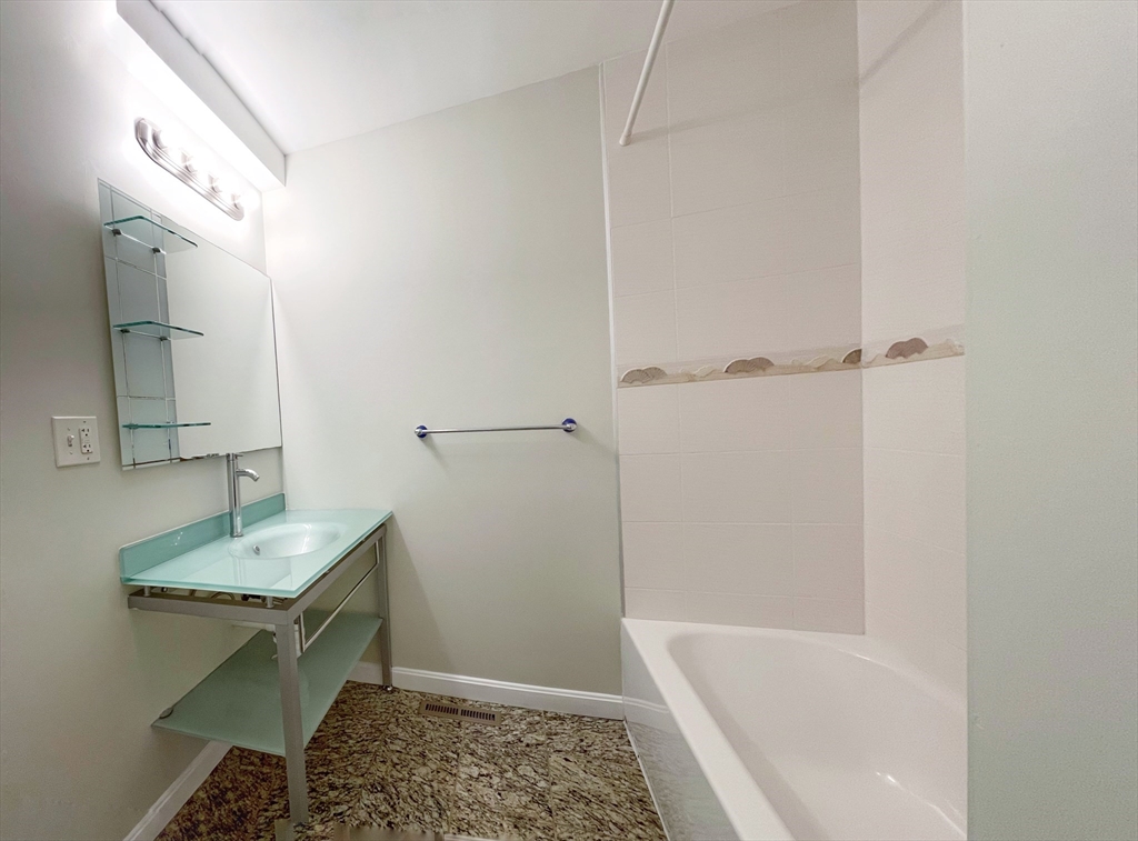 88-90 George Street Boston, MA 02119 - Photo 9 of 15 a bathroom with a granite countertop sink and a mirror