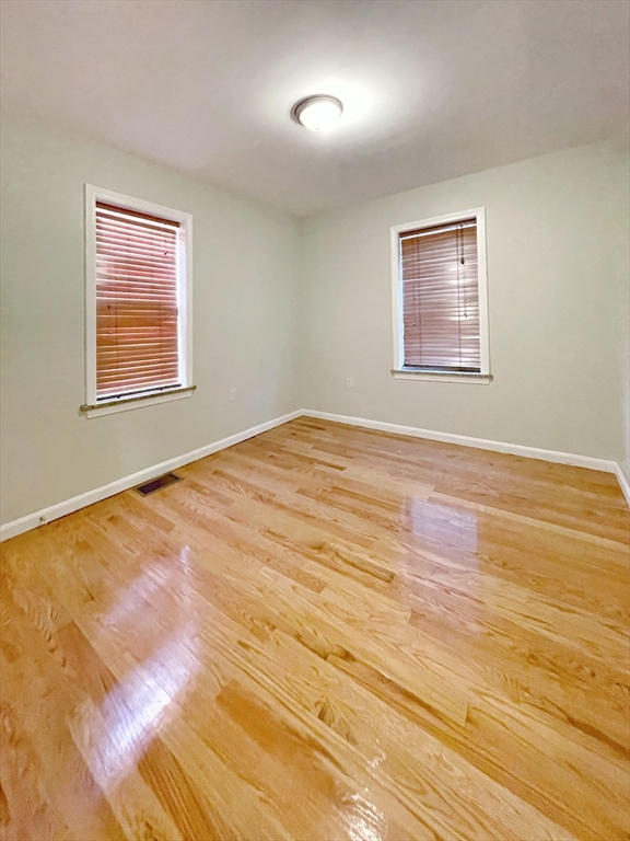 88-90 George Street Boston, MA 02119 - Photo 10 of 15 a view of an empty room with wooden floor and a window
