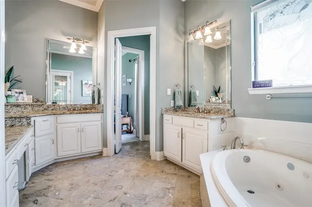 a bathroom with a tub sink and mirror