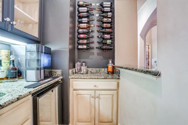 a kitchen with granite countertop a sink and cabinets