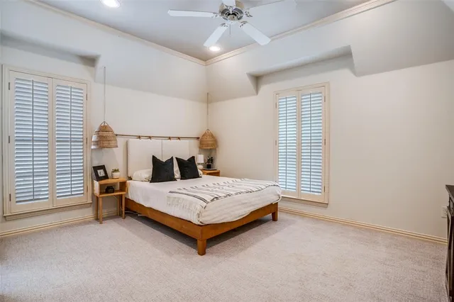 a spacious bedroom with a bed and a chandelier