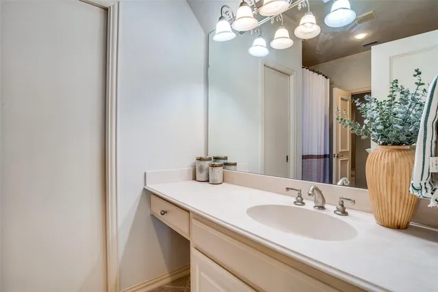 a bathroom with a sink vanity and a mirror