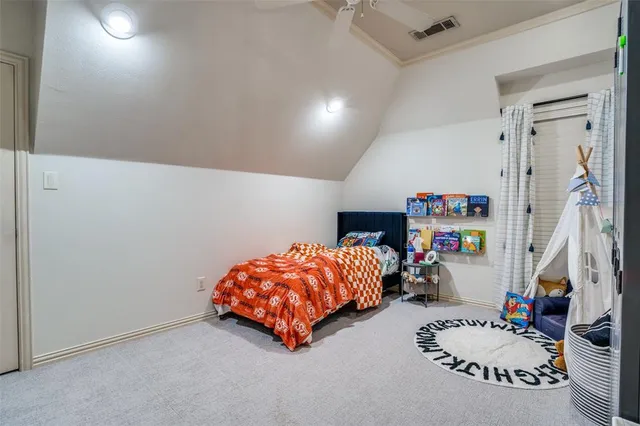 a bedroom with bed and a wooden floor
