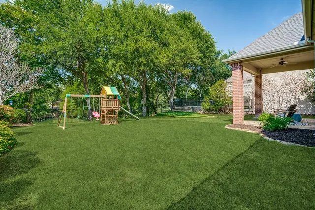 a view of a chair and table in the garden
