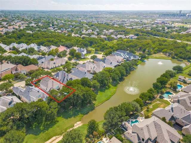 an aerial view of lake residential houses with outdoor space and swimming pool