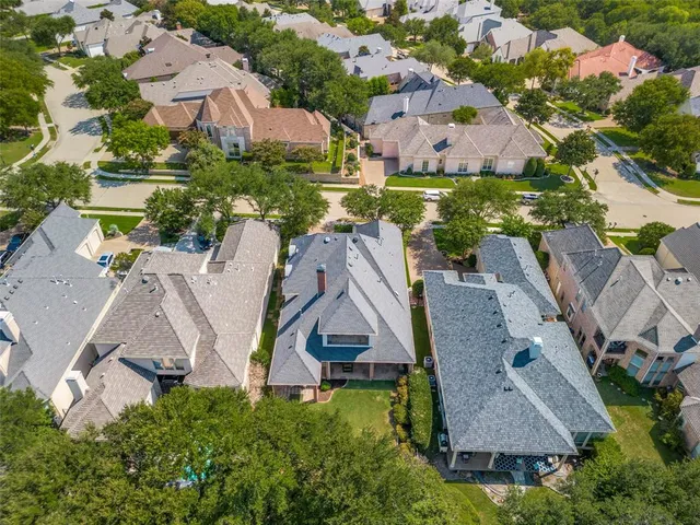 an aerial view of residential houses with outdoor space and street view