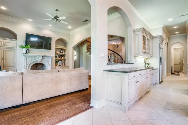 a large white kitchen with a large window a sink and a stove