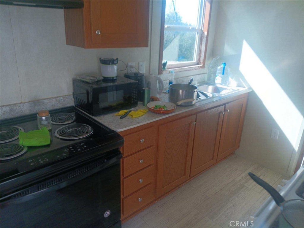 1403 Forbestown Road Oroville, CA 95966 - Photo 3 of 26 a kitchen with a sink and a stove next to a window