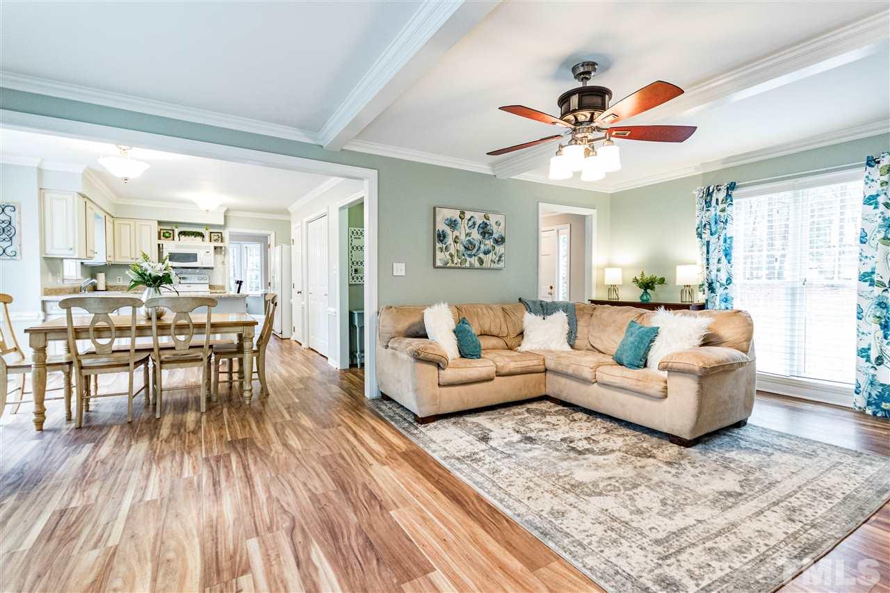 9908 Waterview Road Raleigh, NC 27615 - Photo 3 of 30 a living room with furniture and a wooden floor
