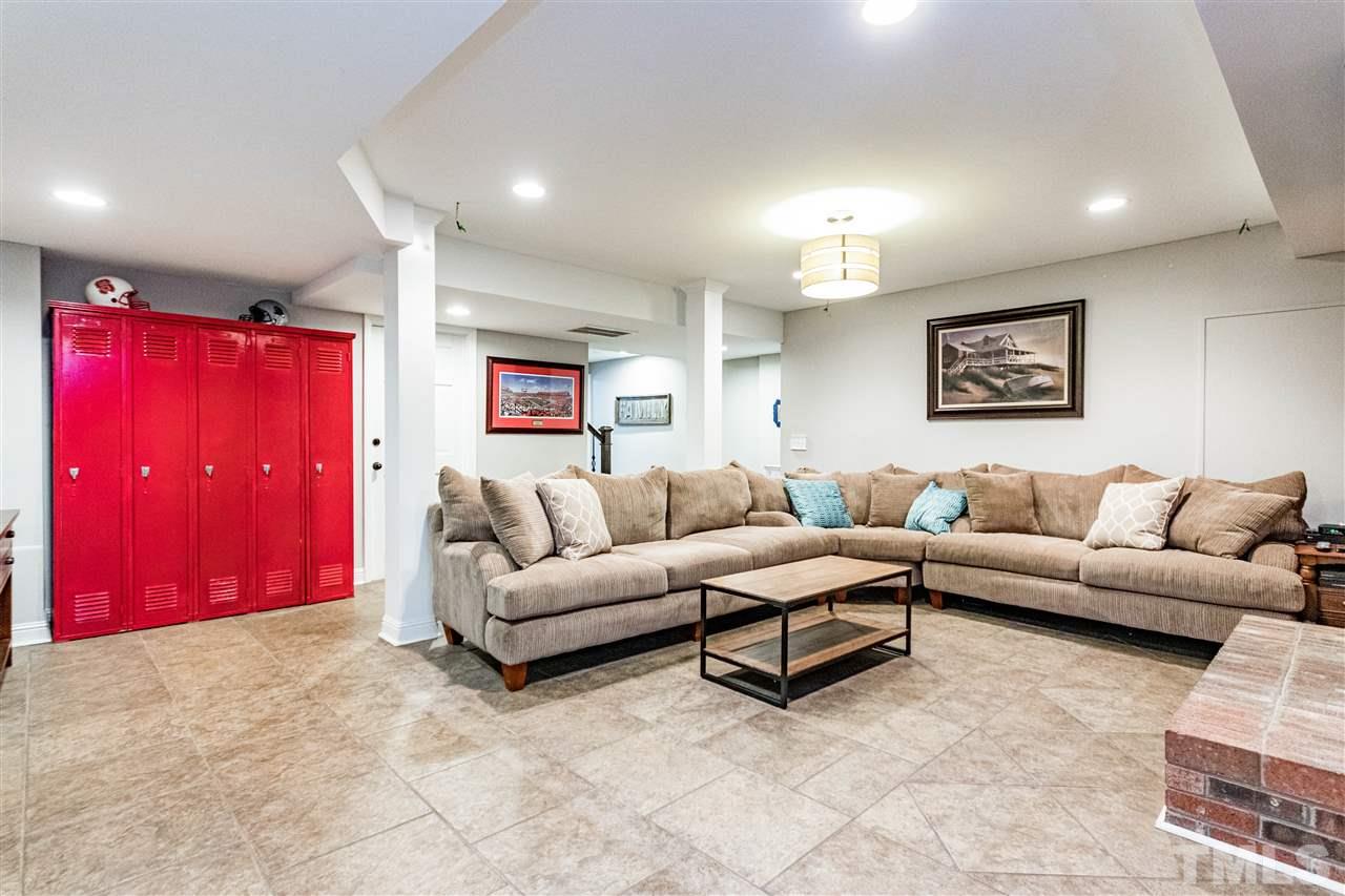 9908 Waterview Road Raleigh, NC 27615 - Photo 22 of 30 a living room with furniture and a walk in closet