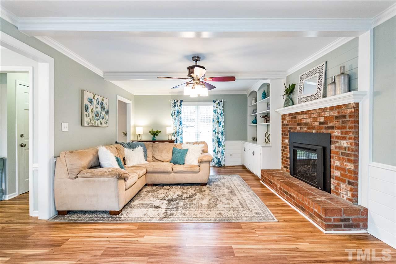 9908 Waterview Road Raleigh, NC 27615 - Photo 4 of 30 a living room with furniture and a fireplace