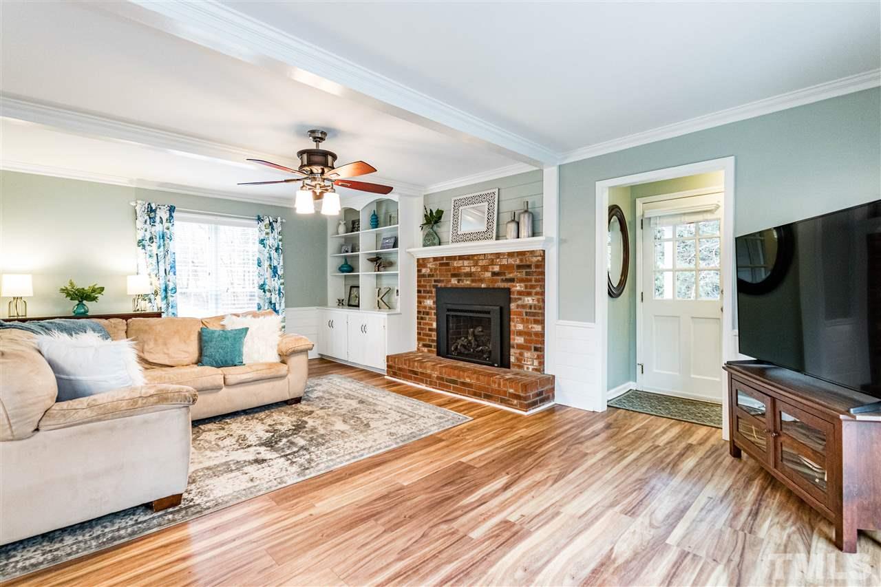 9908 Waterview Road Raleigh, NC 27615 - Photo 5 of 30 a living room with fireplace furniture and a flat screen tv