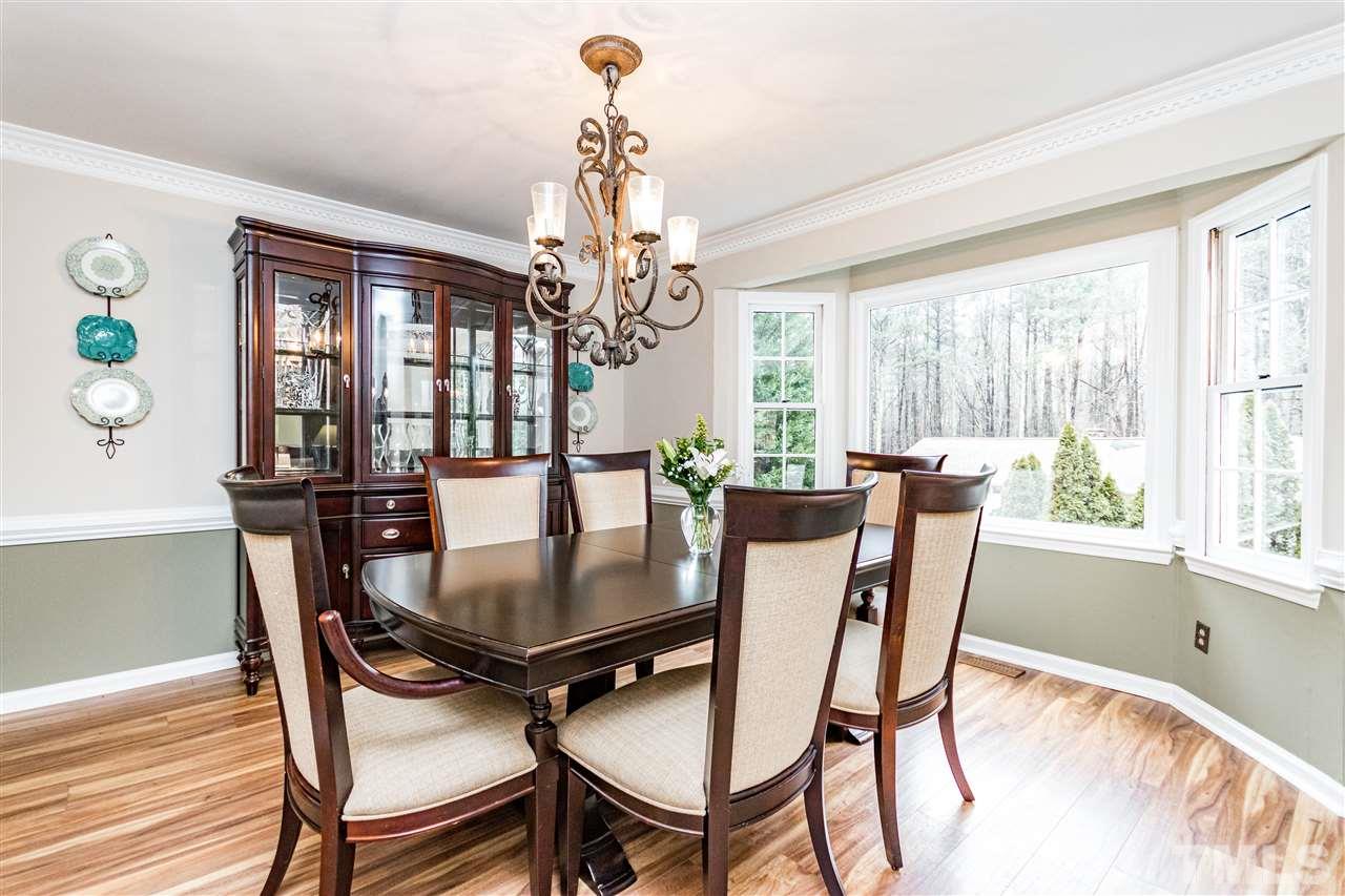 9908 Waterview Road Raleigh, NC 27615 - Photo 8 of 30 a view of a dining room with furniture window and wooden floor