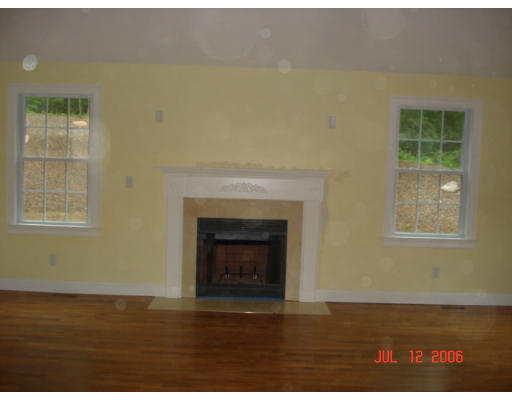 971 Lincoln Road Oakham, MA 01068 - Photo 6 of 13 a view of an empty room with a fireplace