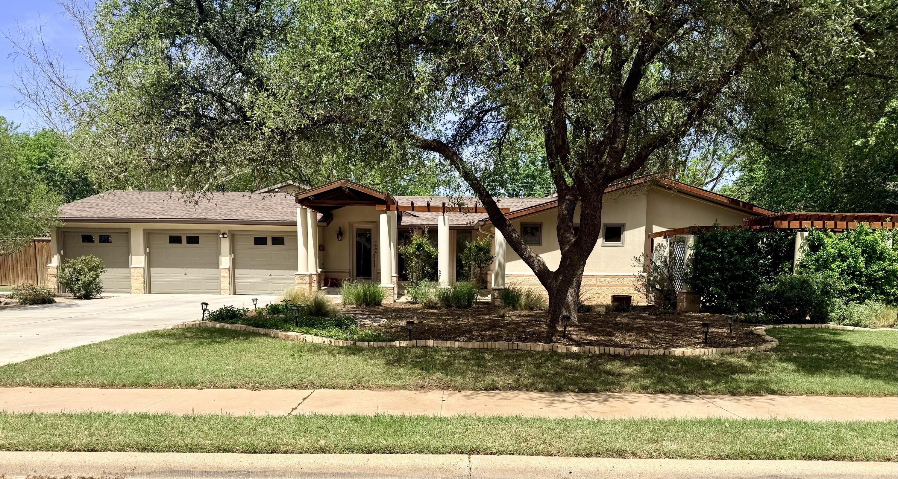 4406 15th Street Lubbock, TX 79416 - Photo 1 of 61 front view of a house with a yard