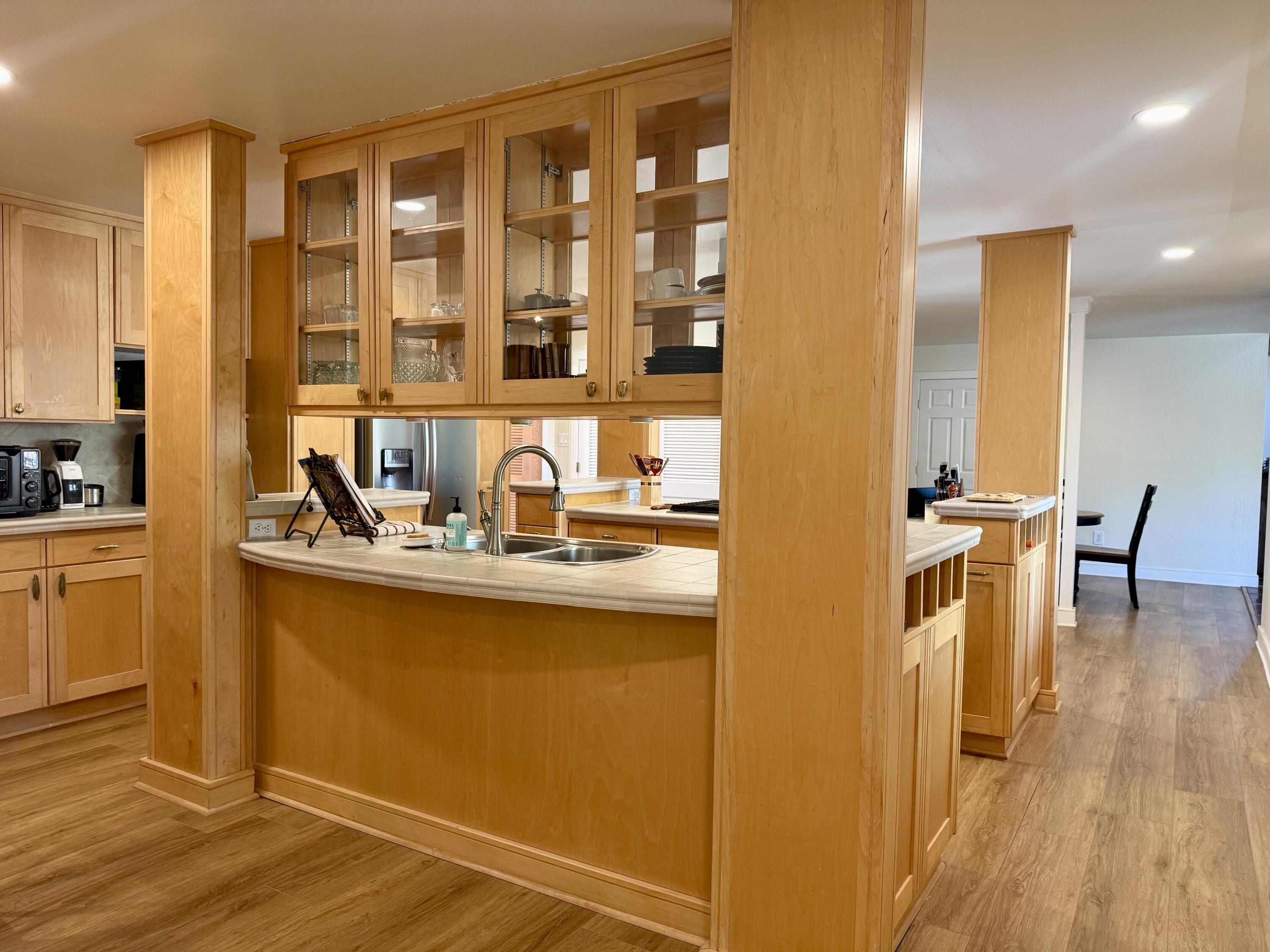 4406 15th Street Lubbock, TX 79416 - Photo 12 of 61 a kitchen with a sink and wooden cabinets