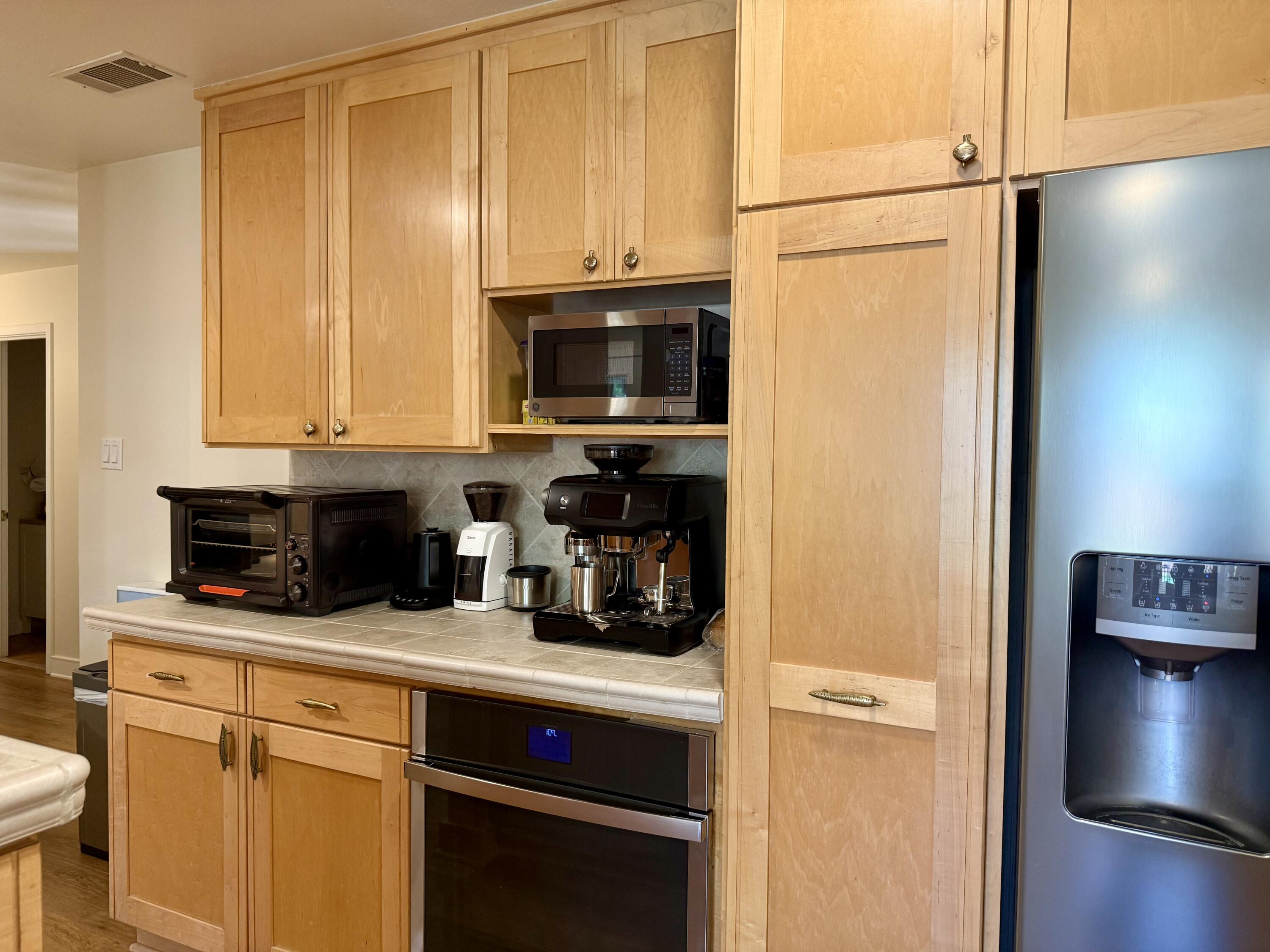 4406 15th Street Lubbock, TX 79416 - Photo 13 of 61 a kitchen with a refrigerator a stove and a microwave