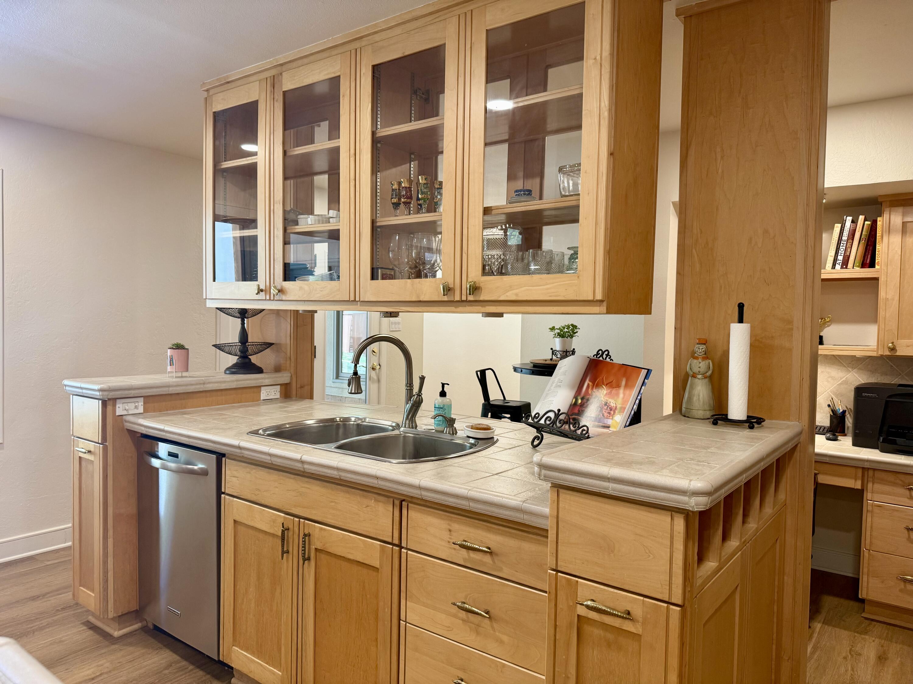 4406 15th Street Lubbock, TX 79416 - Photo 14 of 61 a kitchen with a sink stove and cabinets