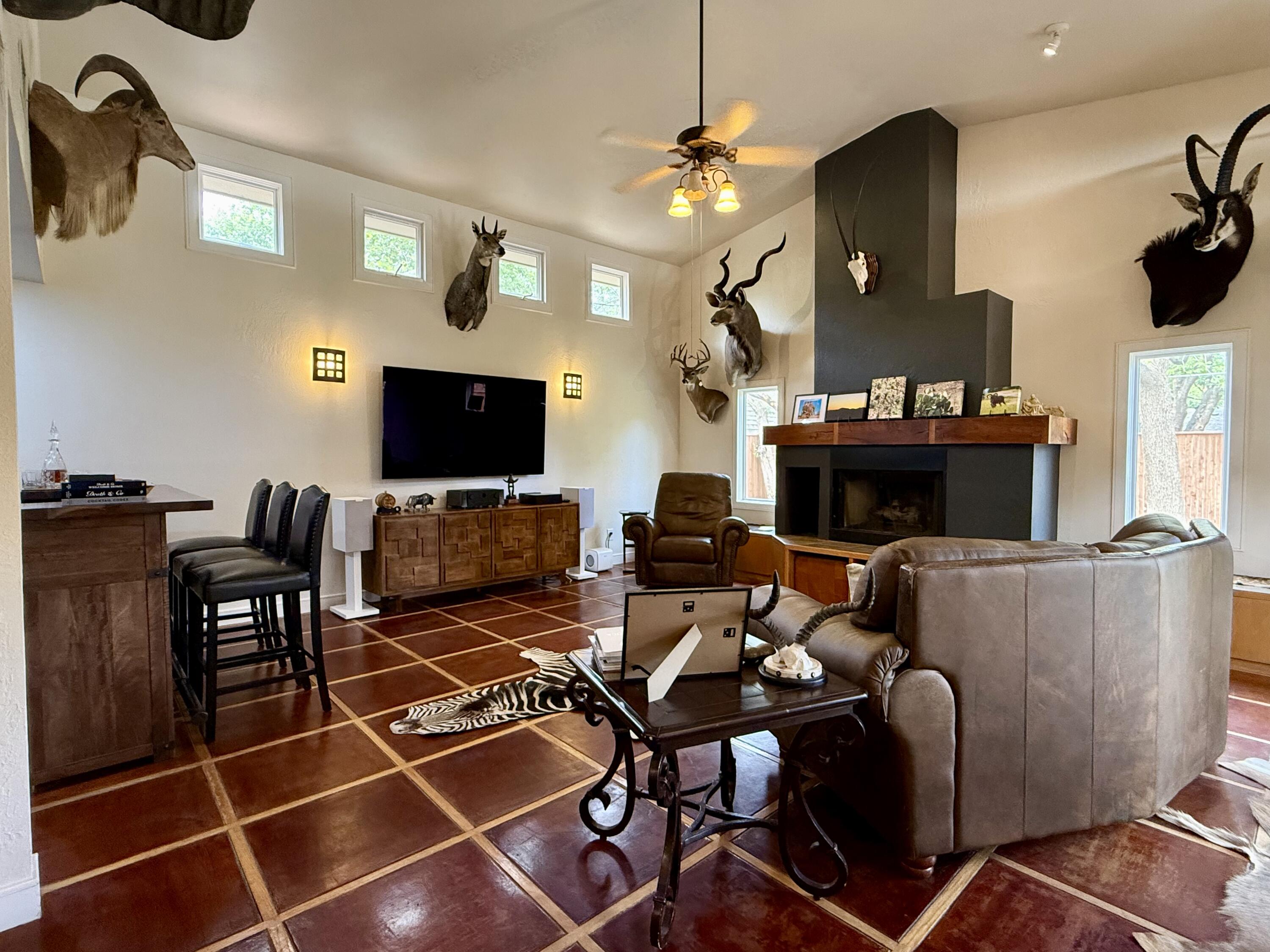 4406 15th Street Lubbock, TX 79416 - Photo 19 of 61 a living room with furniture a flat screen tv and a fireplace
