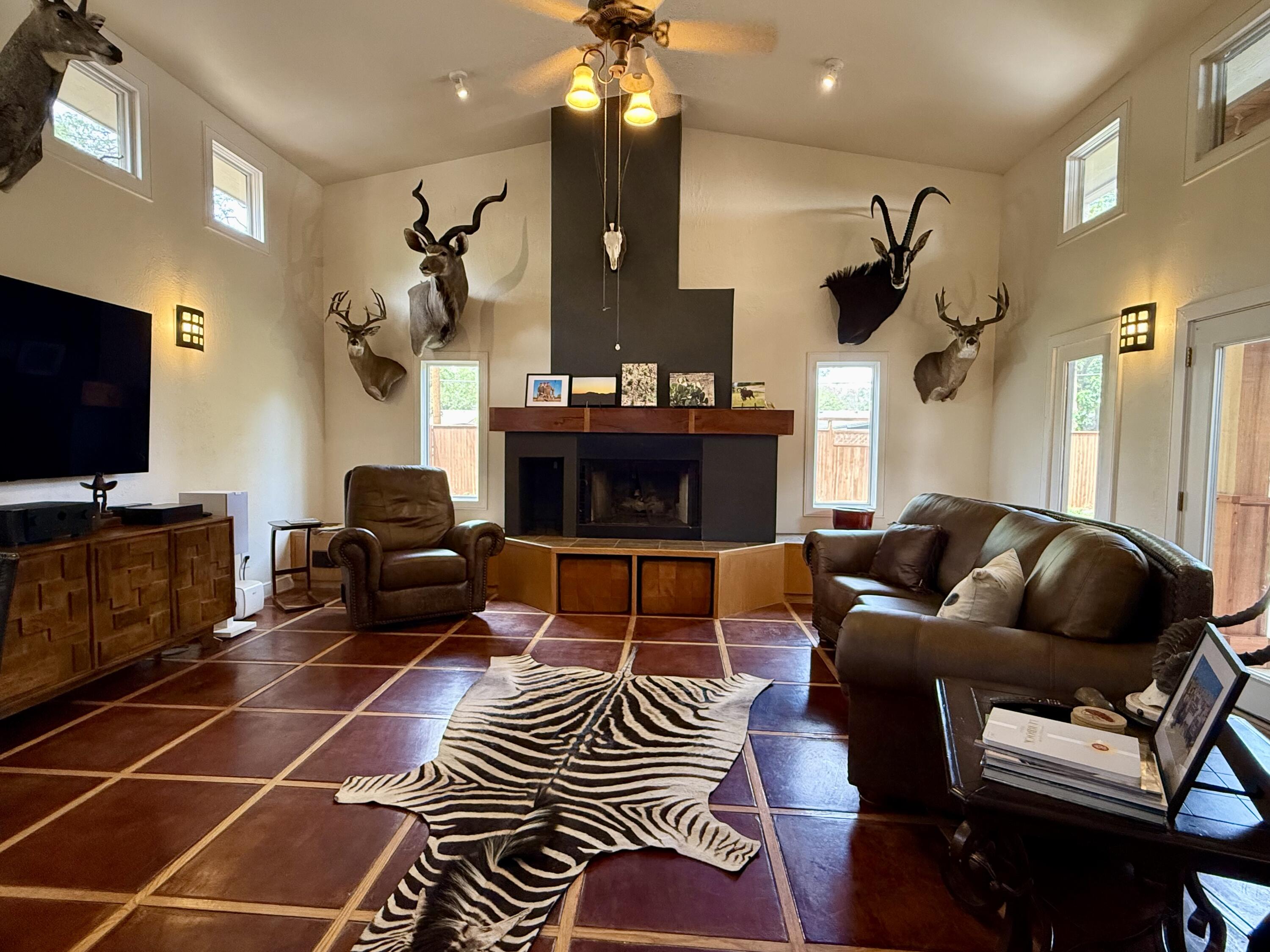 4406 15th Street Lubbock, TX 79416 - Photo 20 of 61 a living room with furniture a flat screen tv and a fireplace