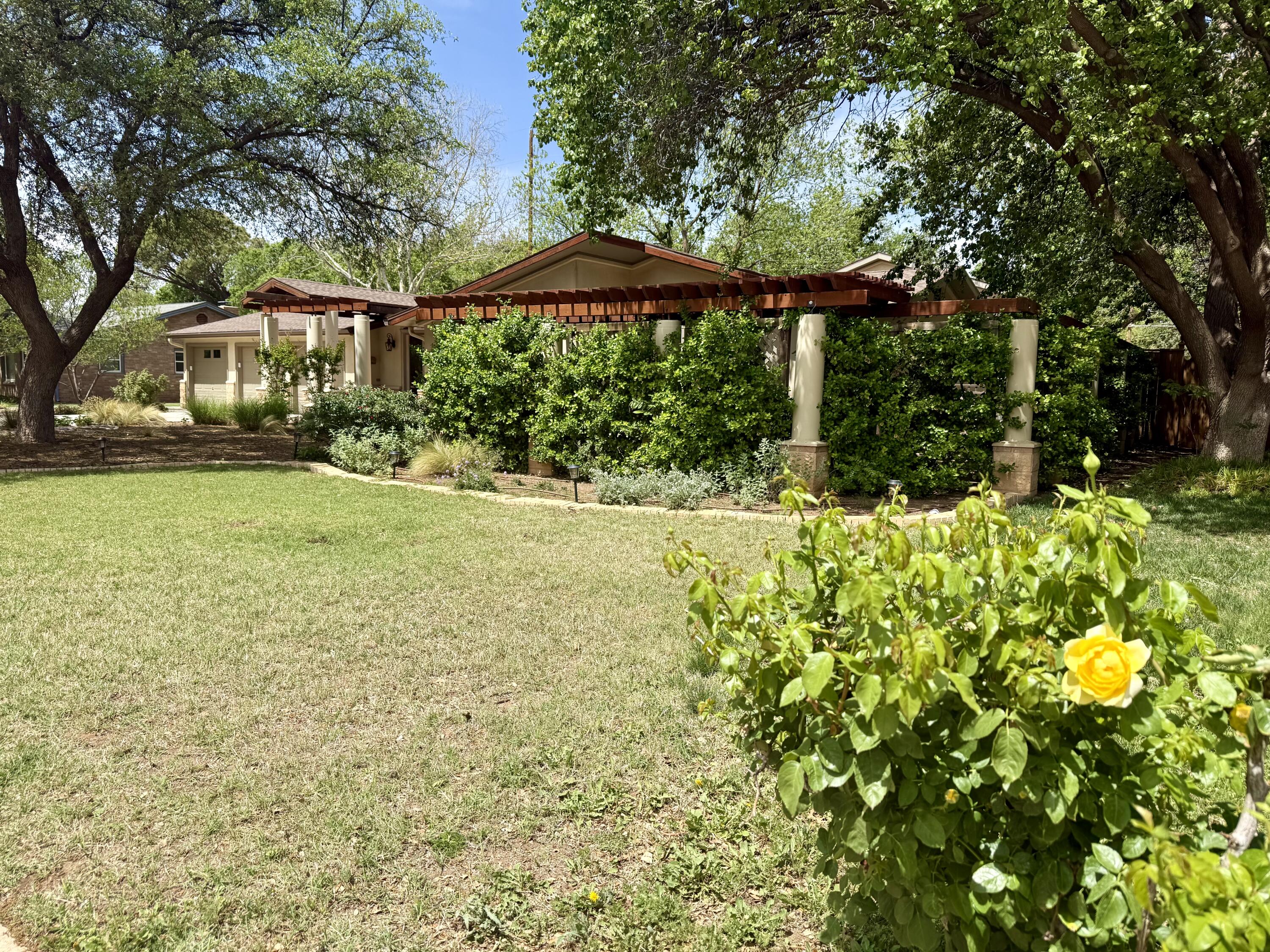 4406 15th Street Lubbock, TX 79416 - Photo 2 of 61 a front view of a house with a yard