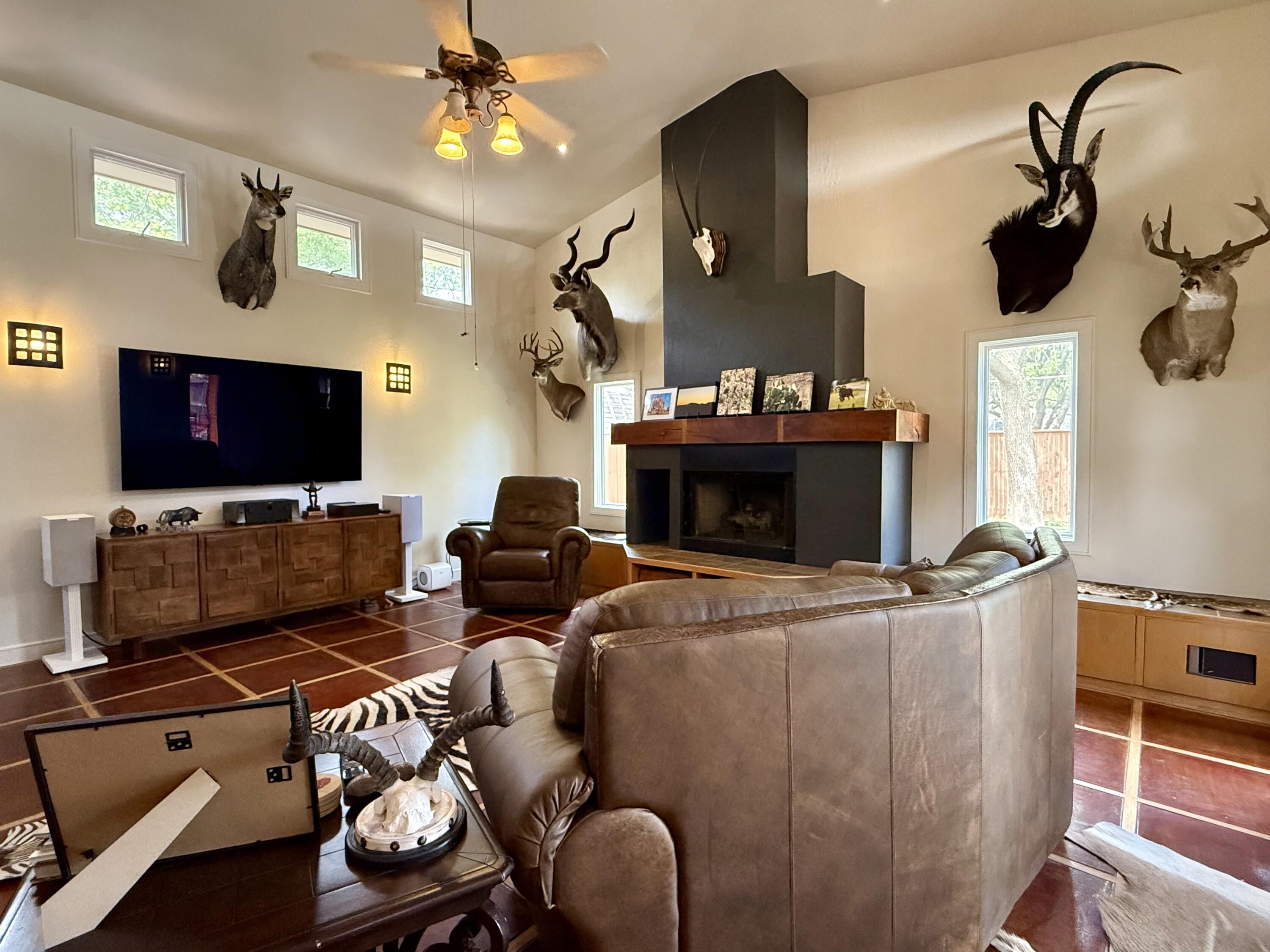 4406 15th Street Lubbock, TX 79416 - Photo 22 of 61 a living room with furniture a flat screen tv and a fireplace