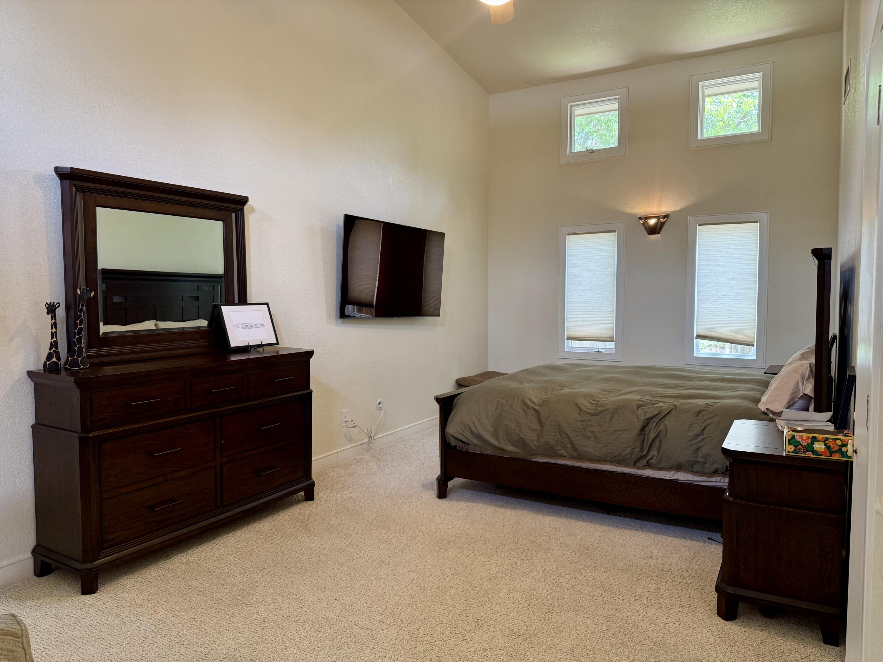4406 15th Street Lubbock, TX 79416 - Photo 28 of 61 a bedroom with a bed and a flat screen television