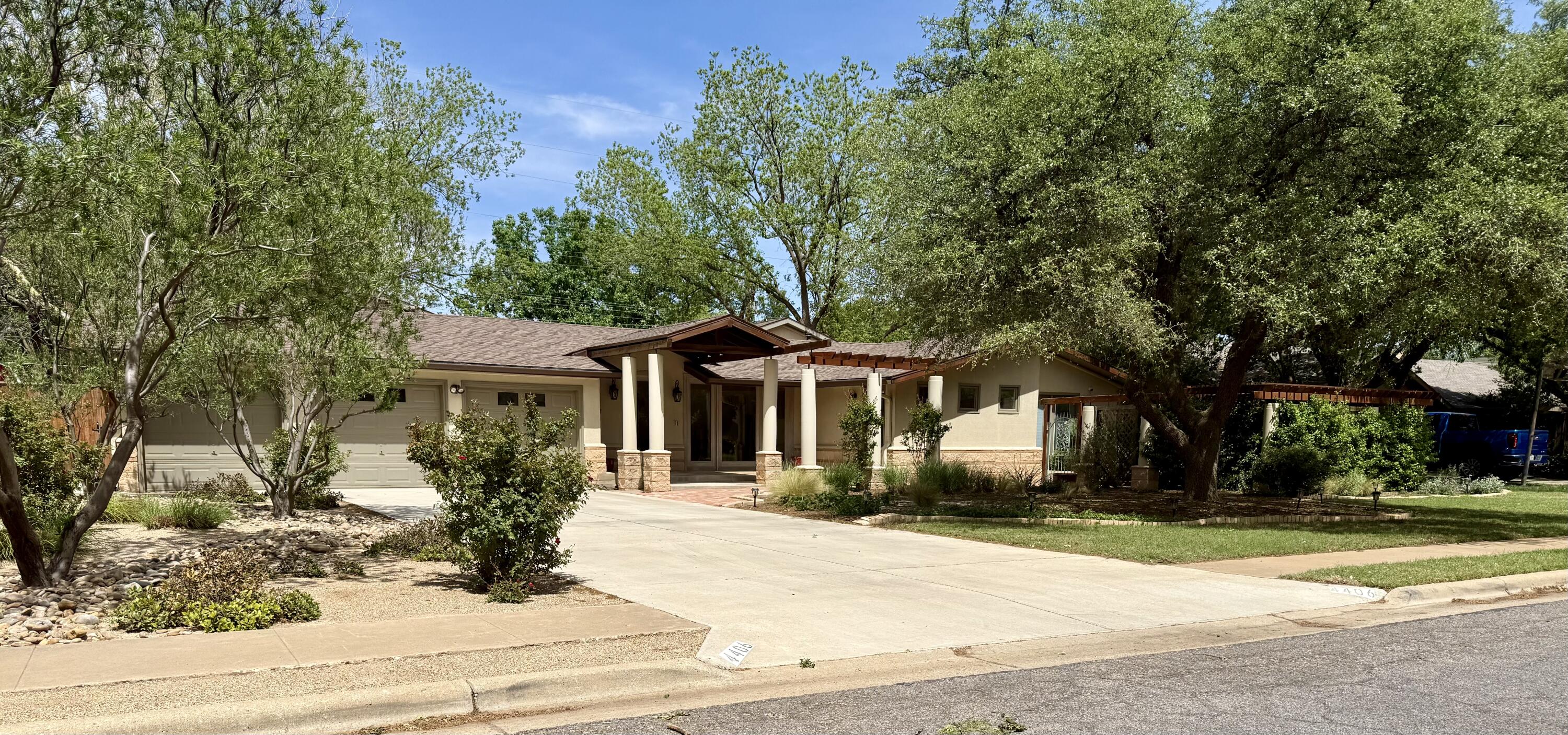 4406 15th Street Lubbock, TX 79416 - Photo 3 of 61 a front view of a house with a yard