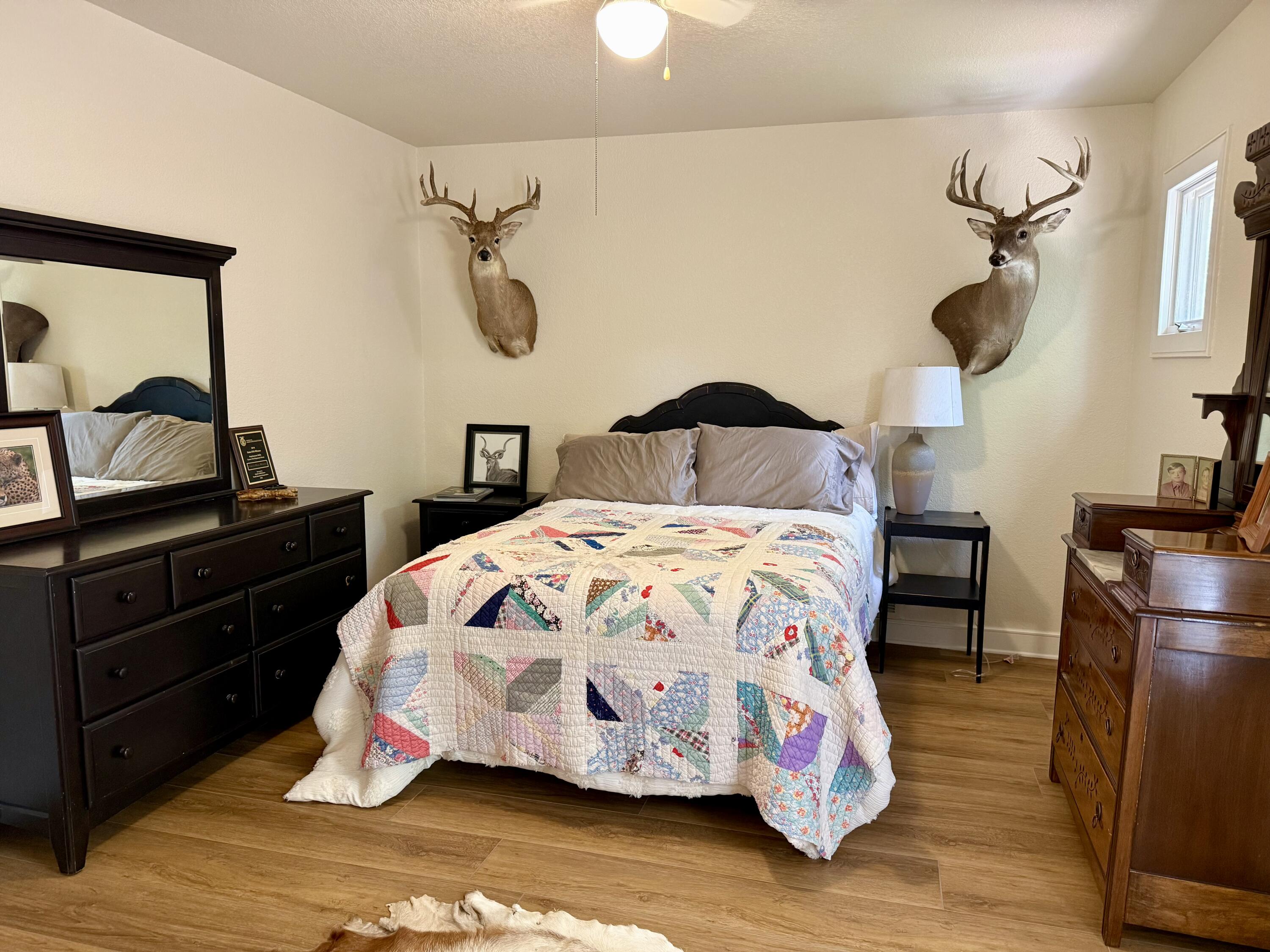 4406 15th Street Lubbock, TX 79416 - Photo 34 of 61 a bedroom with a bed and wooden floor