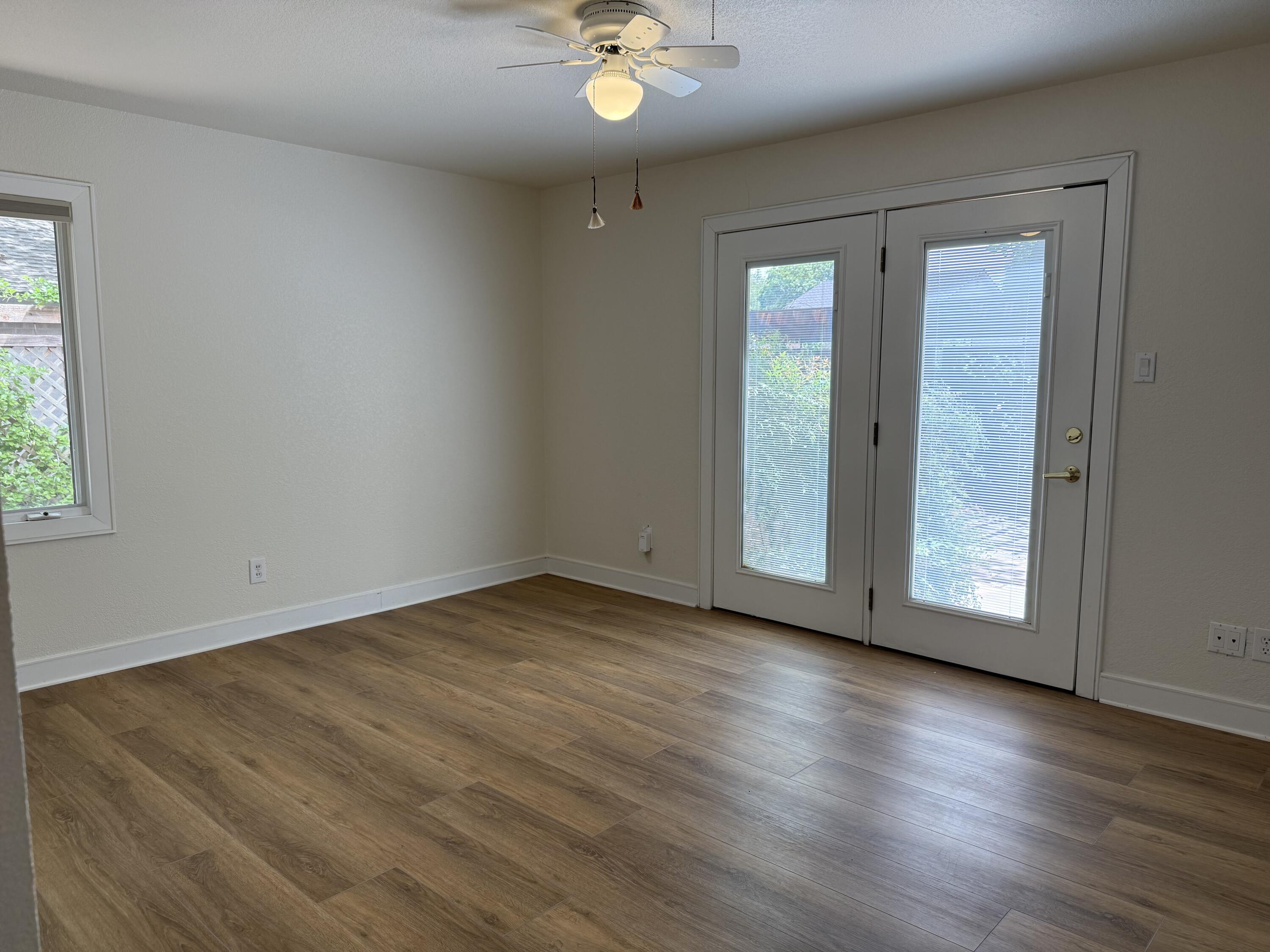 4406 15th Street Lubbock, TX 79416 - Photo 36 of 61 a view of an empty room with wooden floor and a window