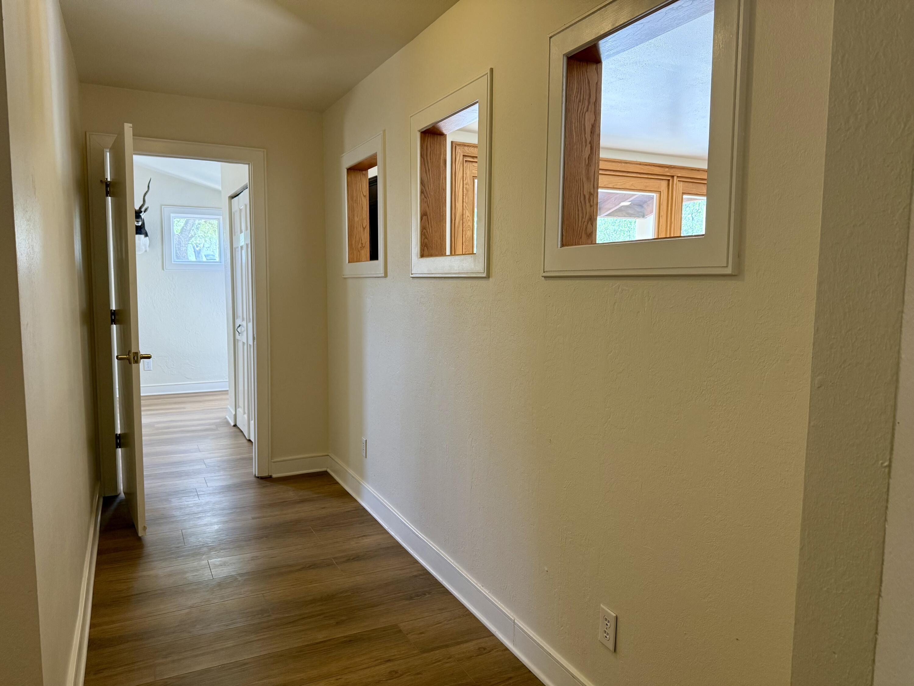 4406 15th Street Lubbock, TX 79416 - Photo 41 of 61 a view of a hallway with wooden floor and a window