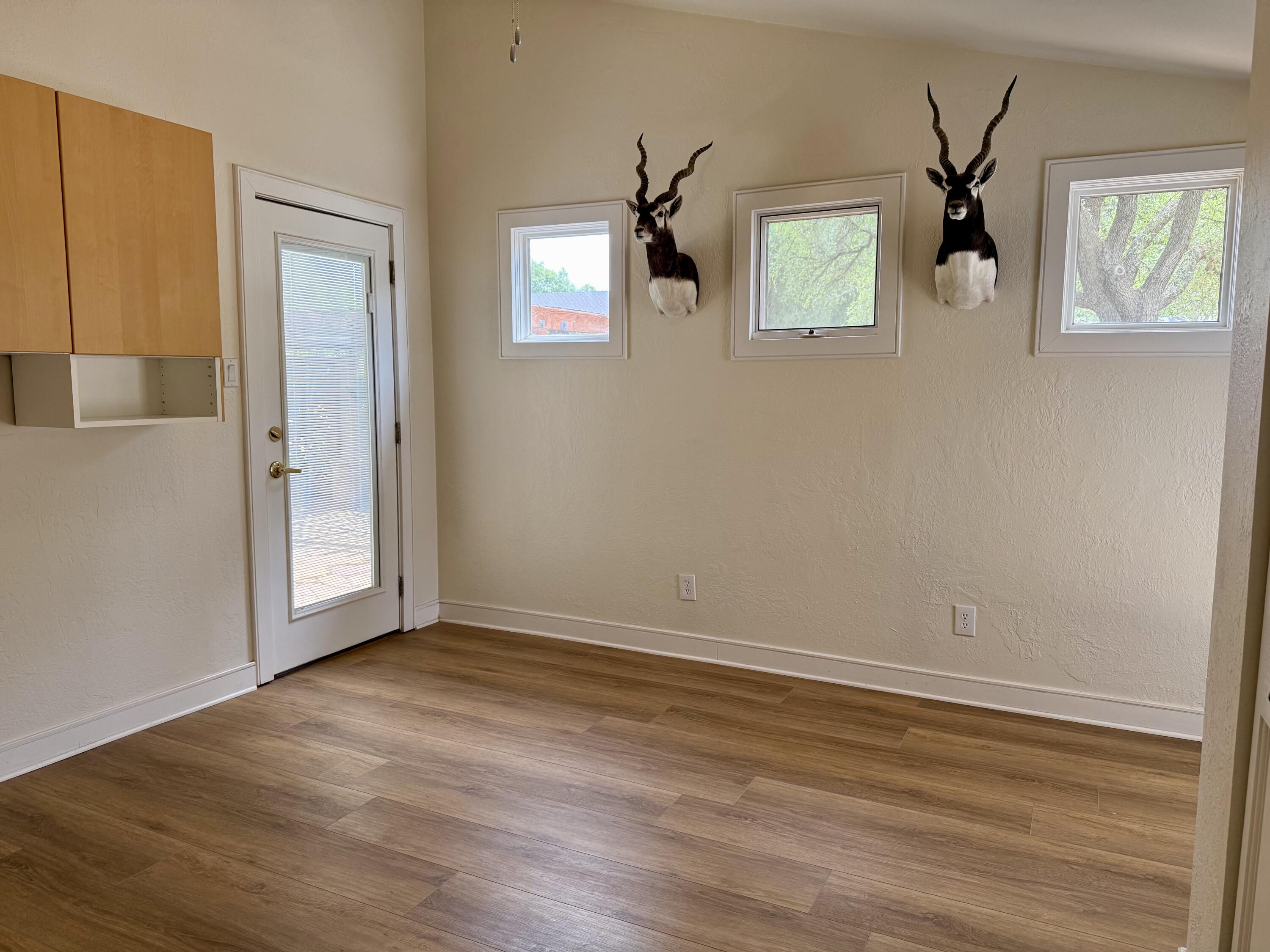 4406 15th Street Lubbock, TX 79416 - Photo 42 of 61 a view of an empty room with wooden floor and a window