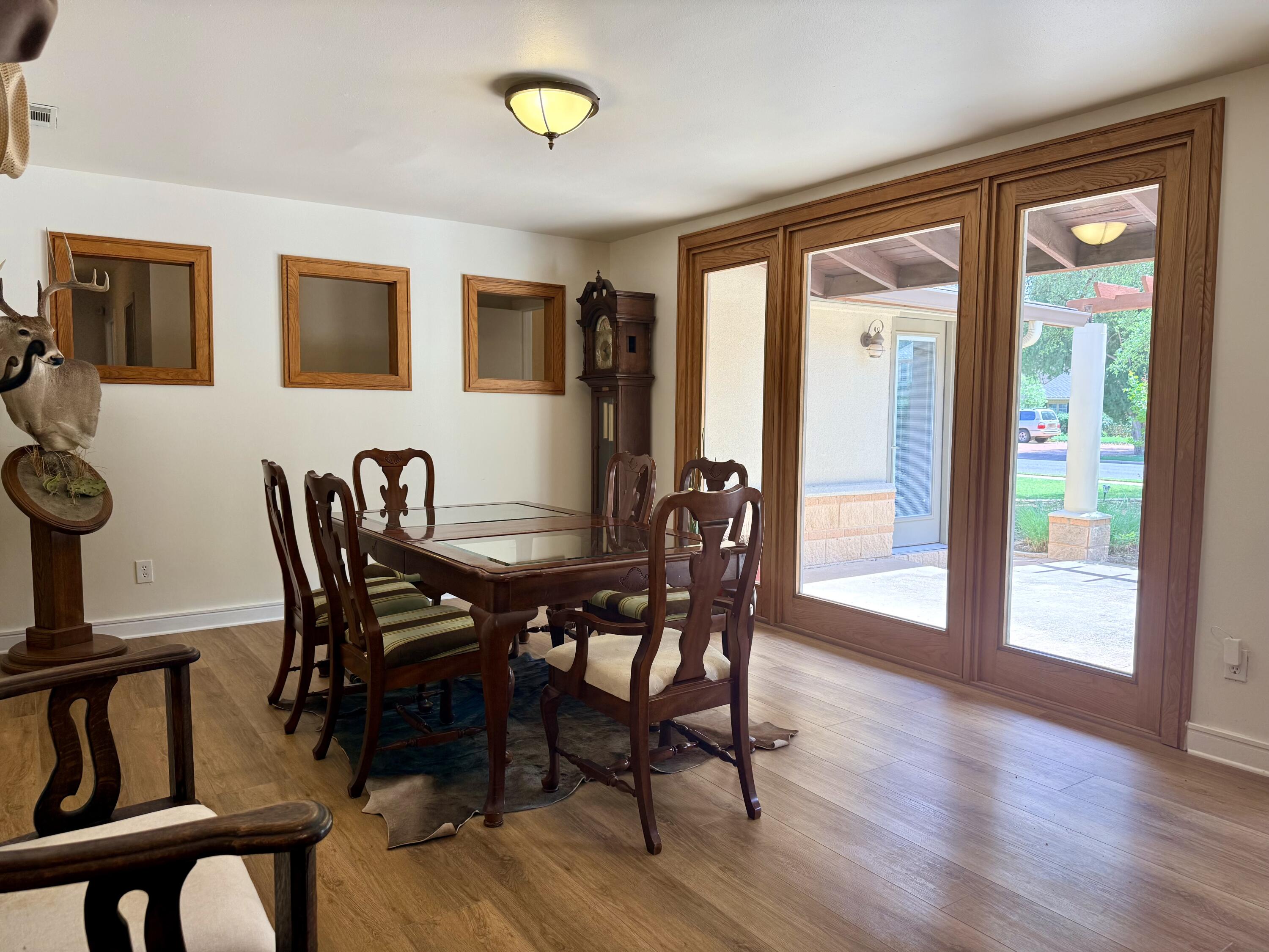 4406 15th Street Lubbock, TX 79416 - Photo 8 of 61 a view of a dining room with furniture and wooden floor
