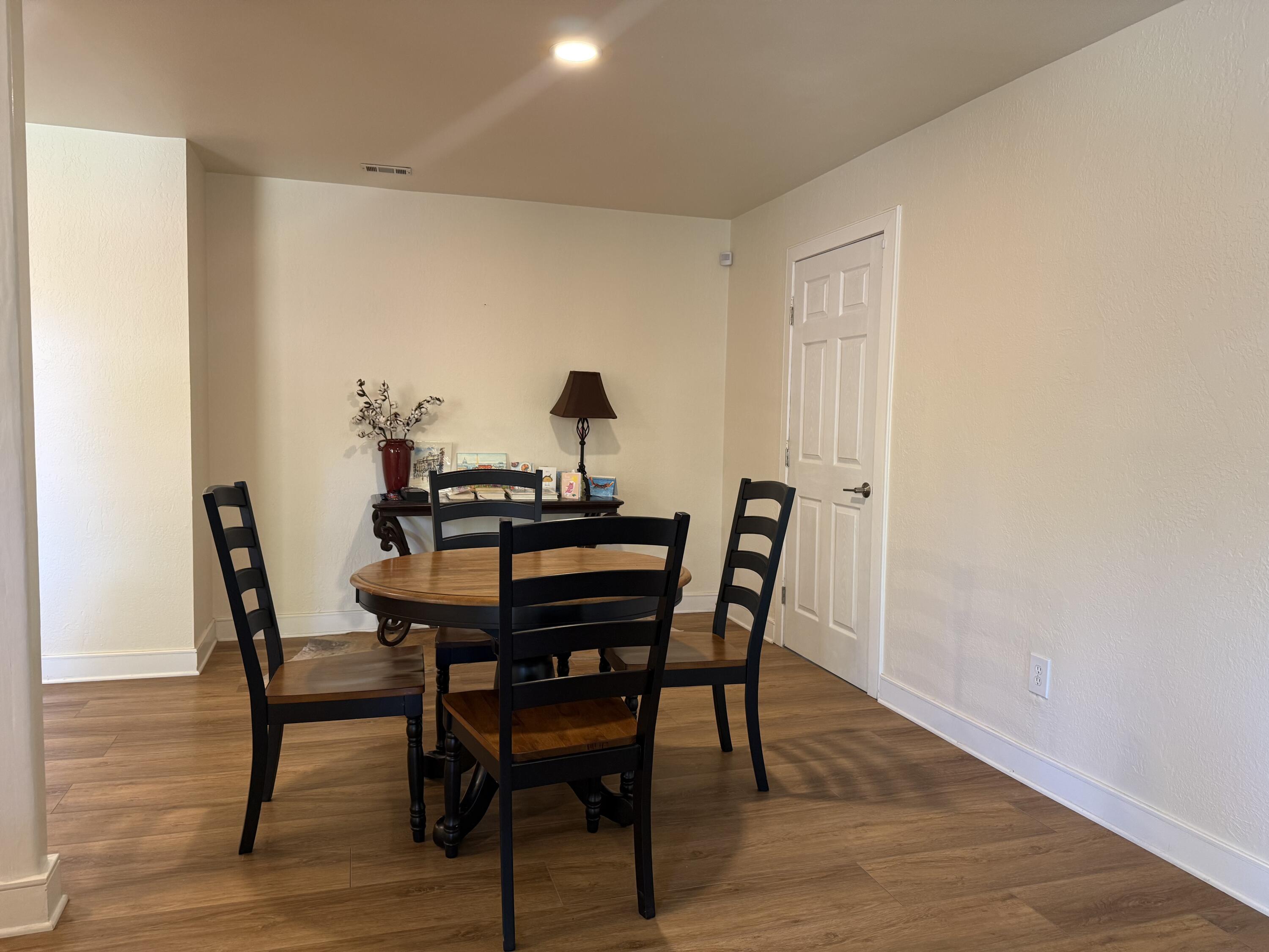4406 15th Street Lubbock, TX 79416 - Photo 9 of 61 a view of a dining room with furniture and wooden floor