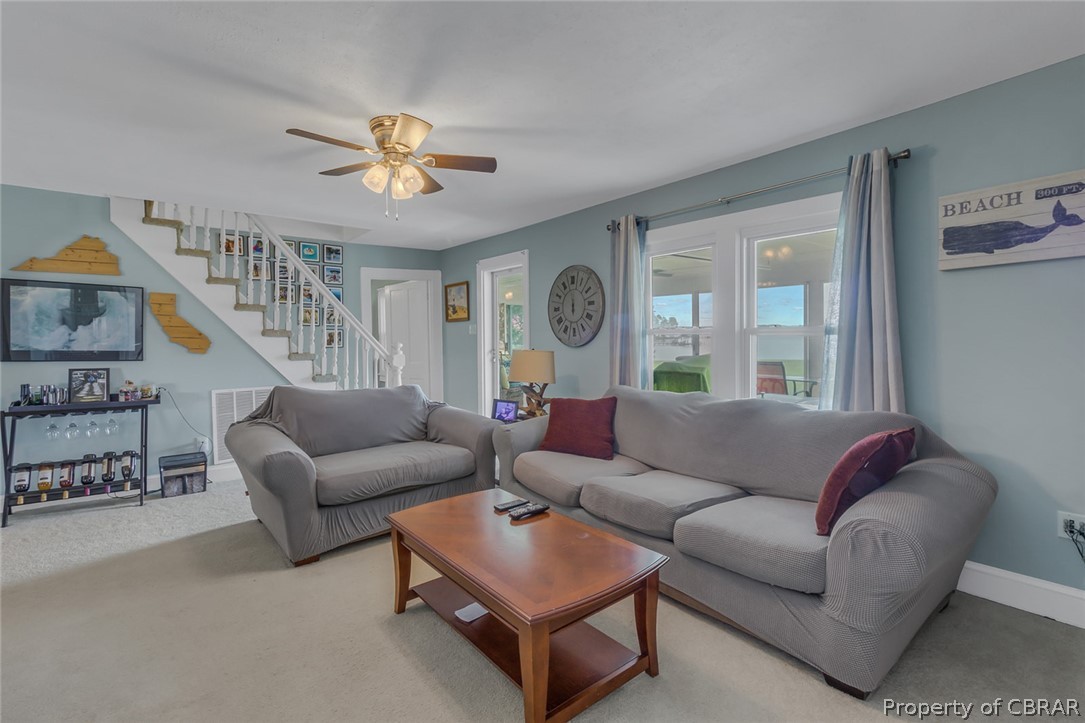 314 Callis Road Lancaster, VA 22503 - Photo 25 of 41 a living room with furniture and a chandelier