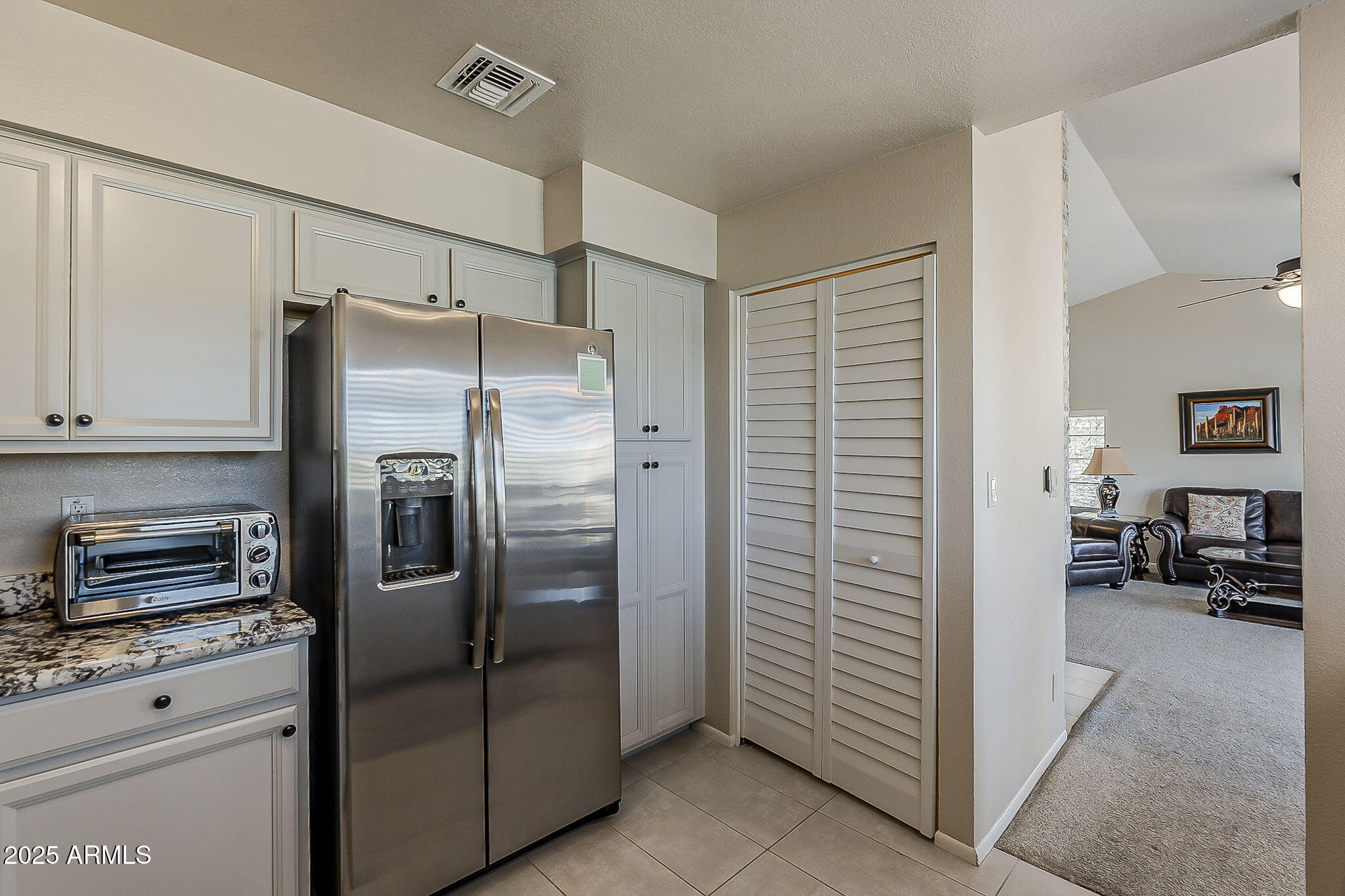 9707 East Mountain View Road, Unit 2412 Scottsdale, AZ 85258 - Photo 17 of 43 a kitchen with stainless steel appliances granite countertop a refrigerator and a stove