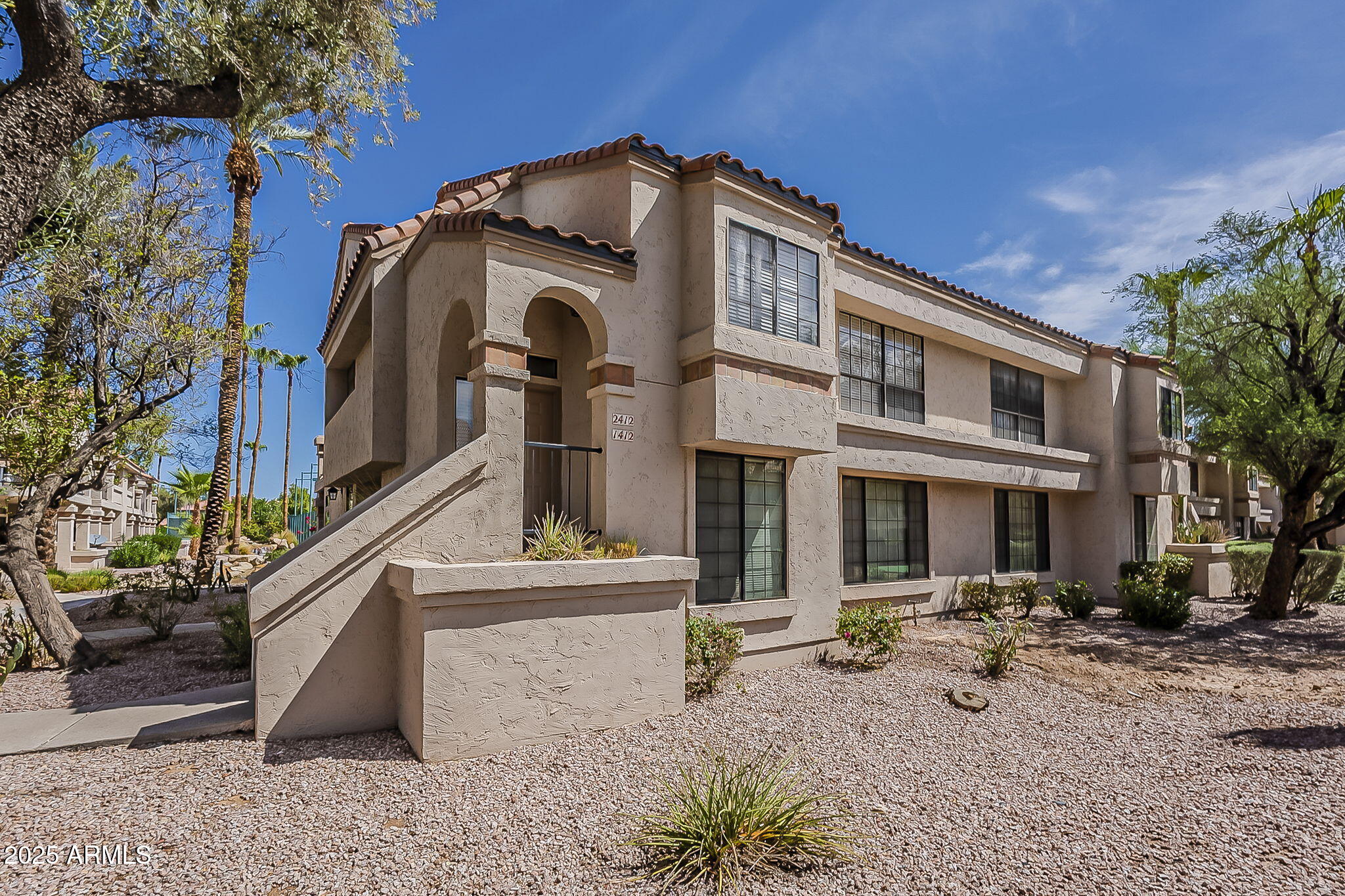 9707 East Mountain View Road, Unit 2412 Scottsdale, AZ 85258 - Photo 2 of 43 a front view of a building with sitting area
