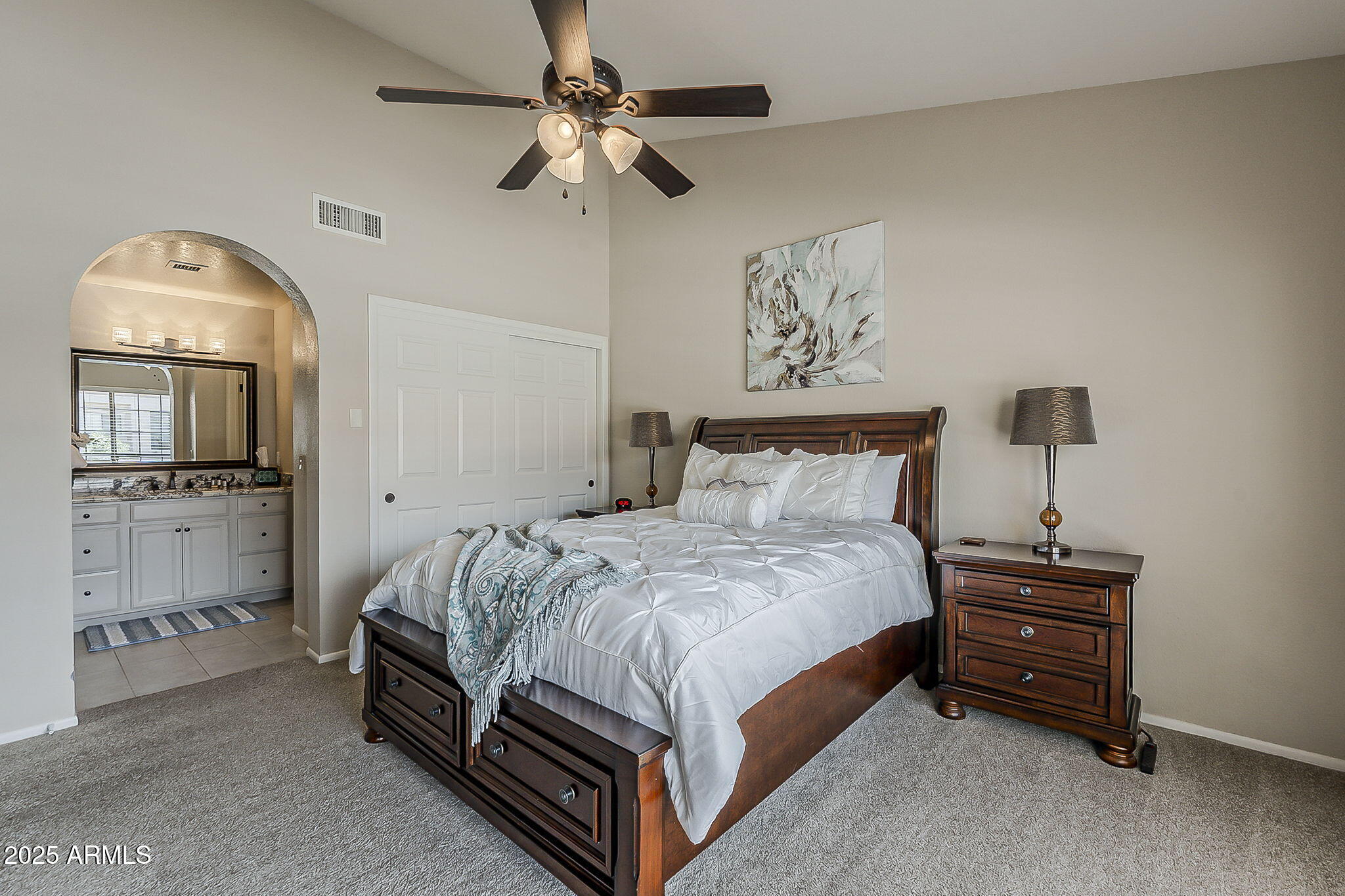 9707 East Mountain View Road, Unit 2412 Scottsdale, AZ 85258 - Photo 23 of 43 a bedroom with a bed and a chandelier
