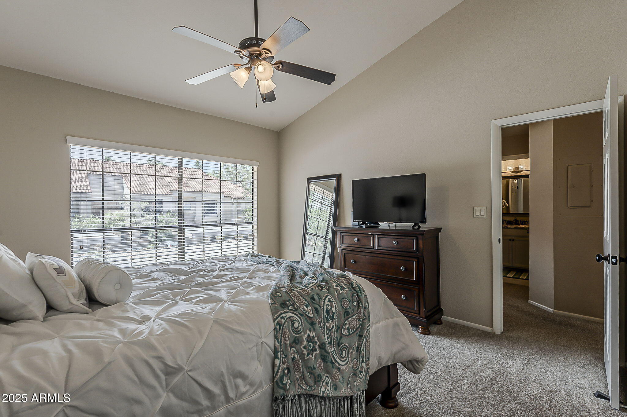 9707 East Mountain View Road, Unit 2412 Scottsdale, AZ 85258 - Photo 26 of 43 a bedroom with a bed and a flat screen tv
