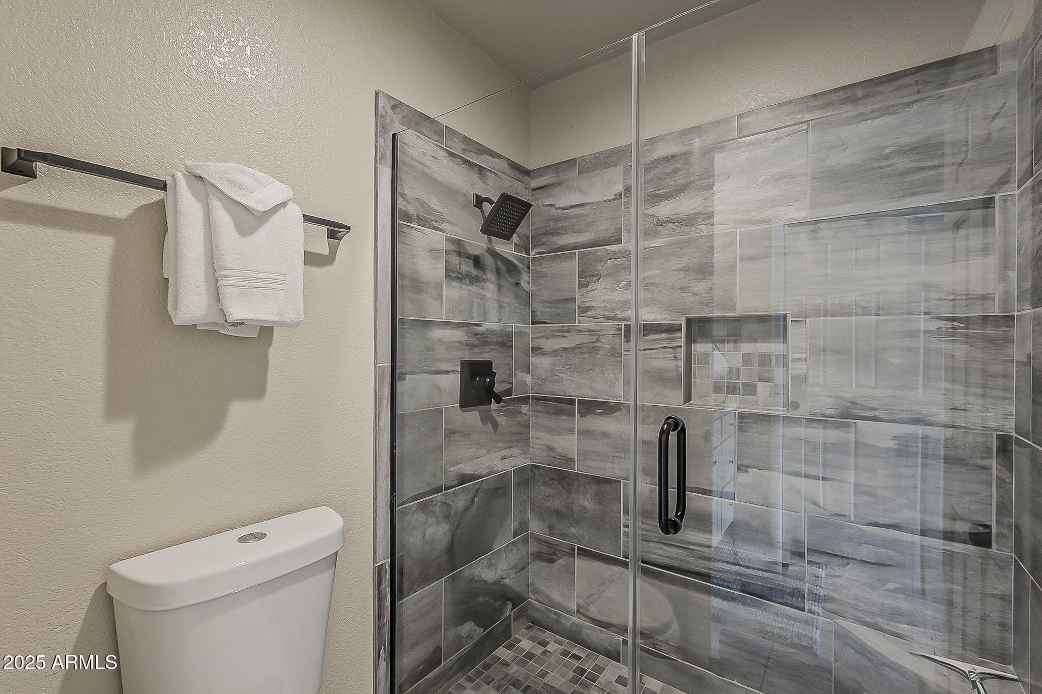 9707 East Mountain View Road, Unit 2412 Scottsdale, AZ 85258 - Photo 28 of 43 a bathroom with a shower and toilet