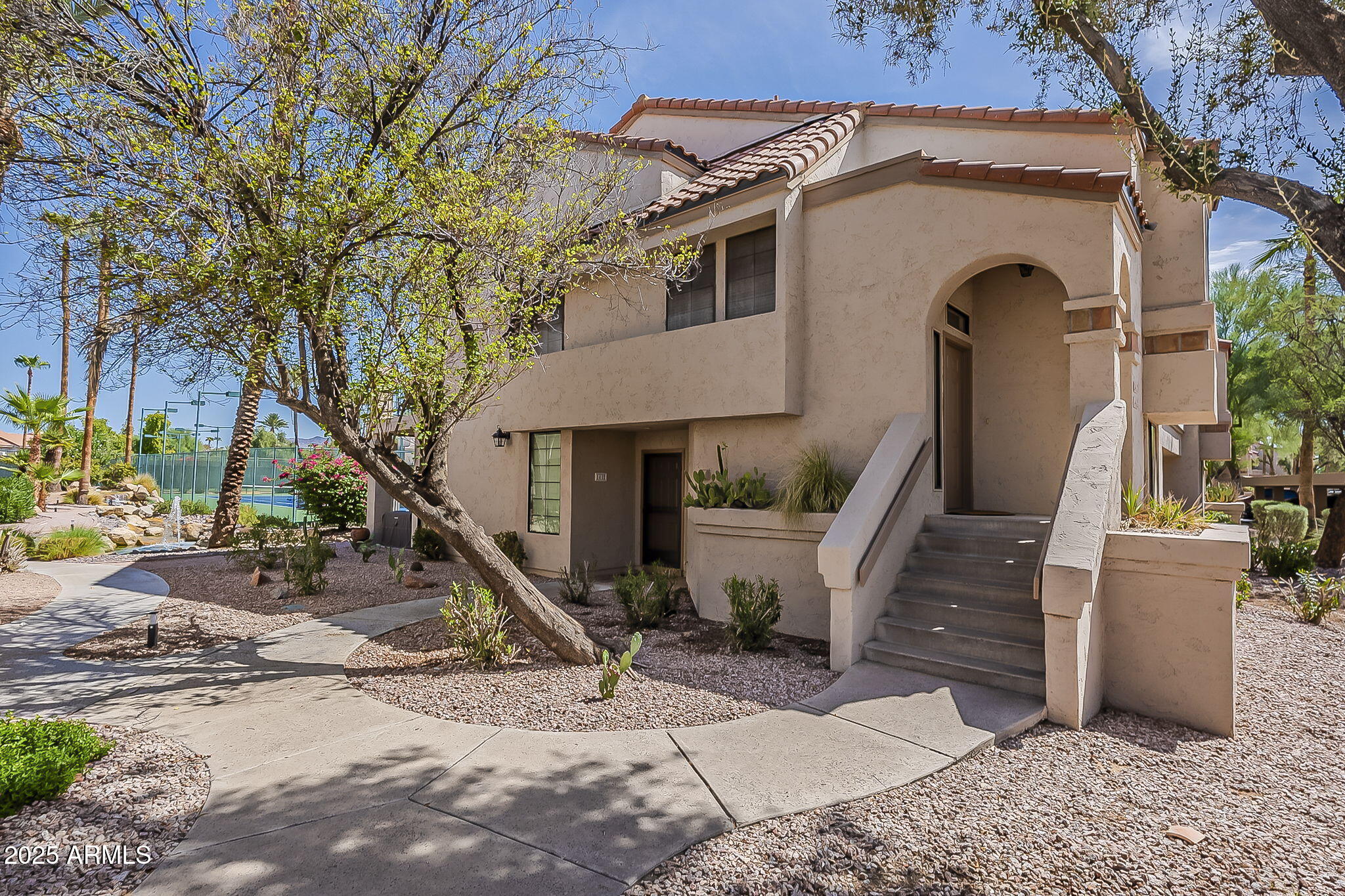 9707 East Mountain View Road, Unit 2412 Scottsdale, AZ 85258 - Photo 3 of 43 a front view of a house with garden