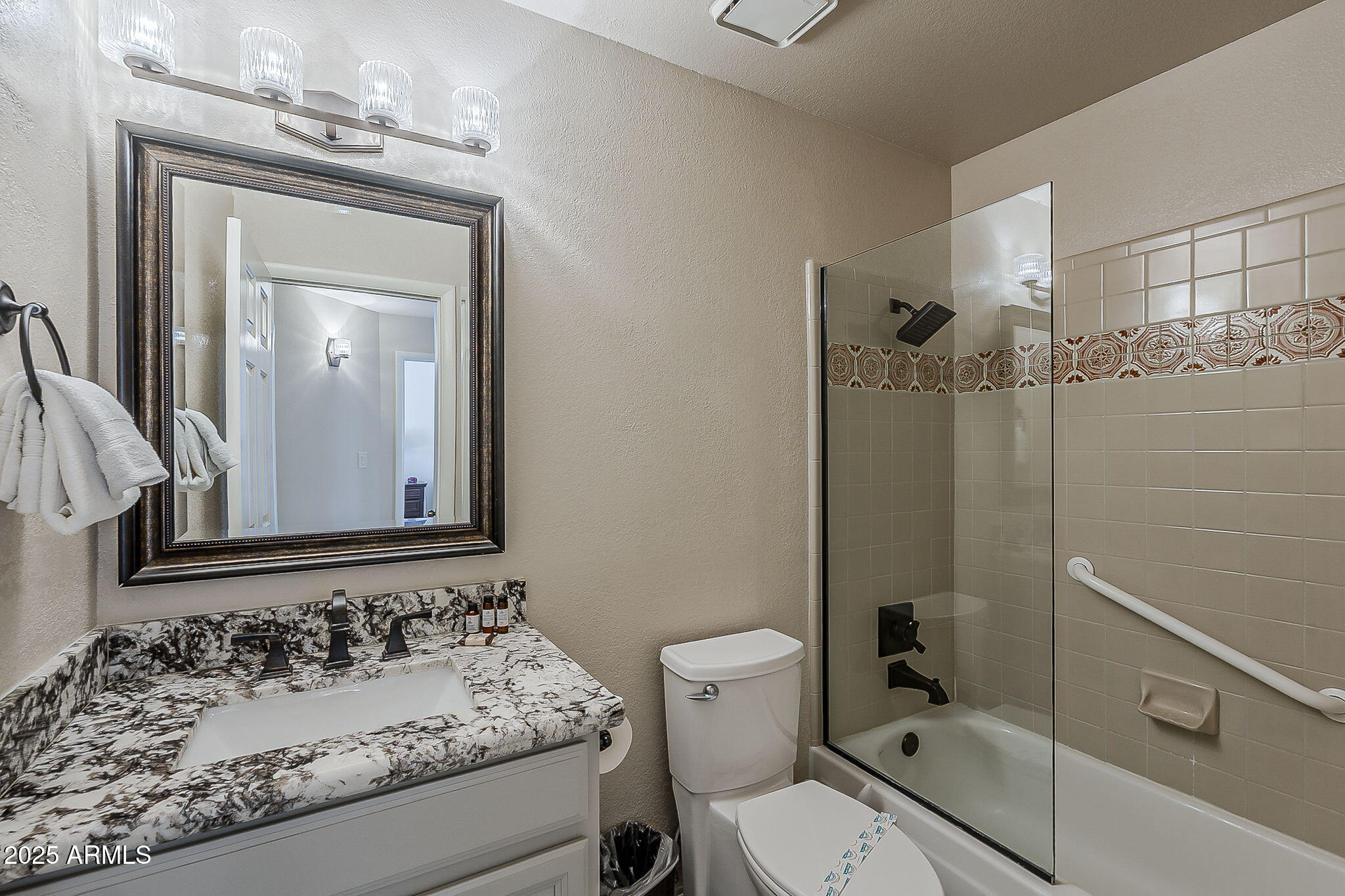 9707 East Mountain View Road, Unit 2412 Scottsdale, AZ 85258 - Photo 32 of 43 a bathroom with a sink toilet and shower
