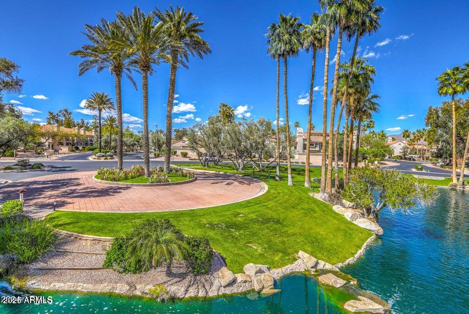9707 East Mountain View Road, Unit 2412 Scottsdale, AZ 85258 - Photo 40 of 43 a view of a swimming pool with a yard