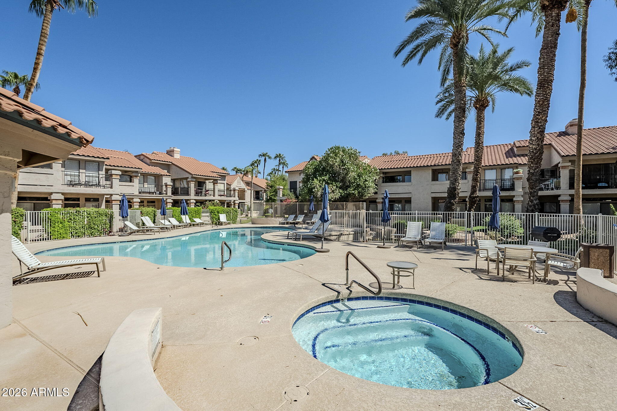 9707 East Mountain View Road, Unit 2412 Scottsdale, AZ 85258 - Photo 44 of 61 a view of swimming pool with outdoor seating and a palm tree