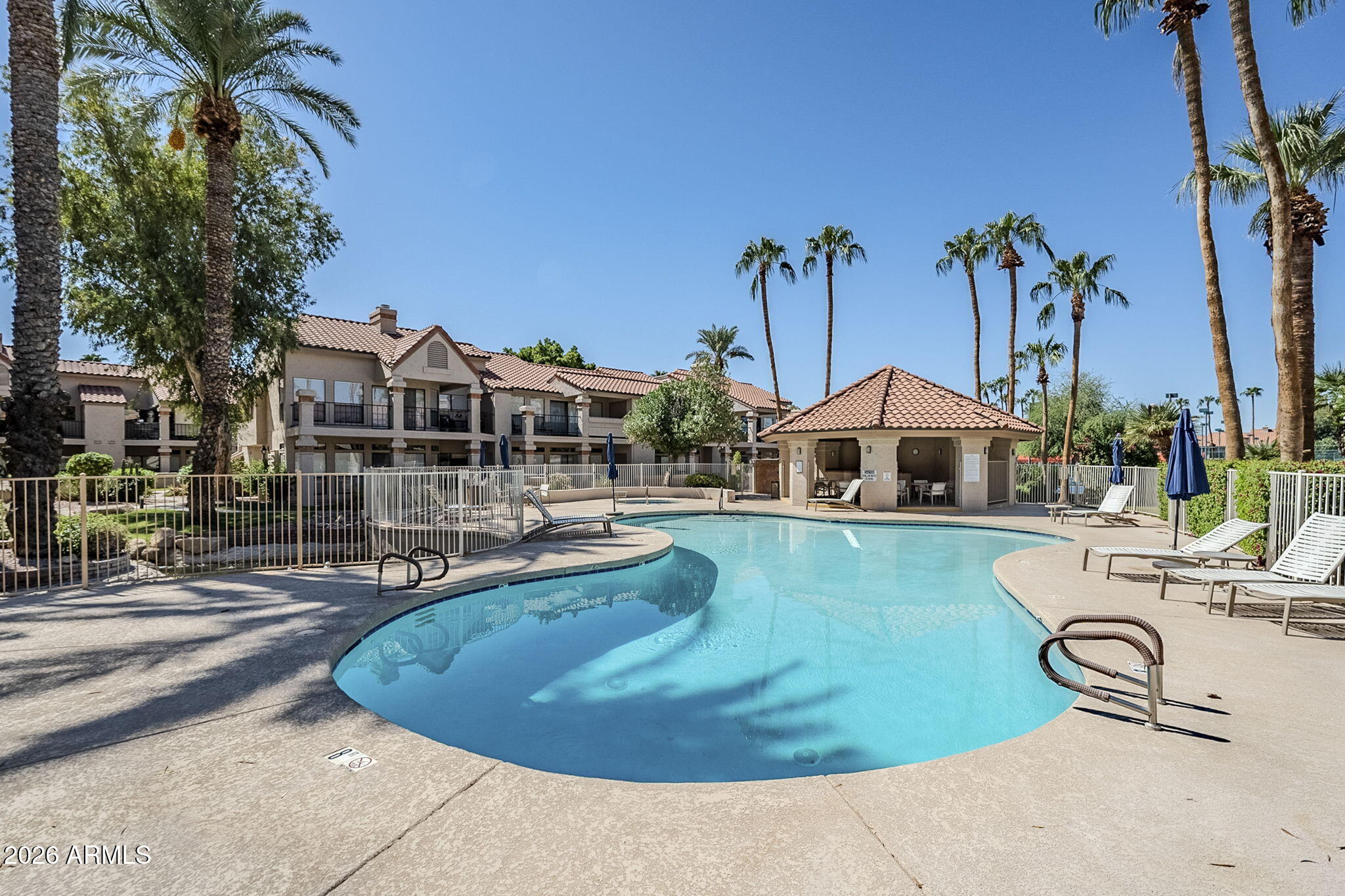 9707 East Mountain View Road, Unit 2412 Scottsdale, AZ 85258 - Photo 45 of 61 a swimming pool with outdoor seating and yard