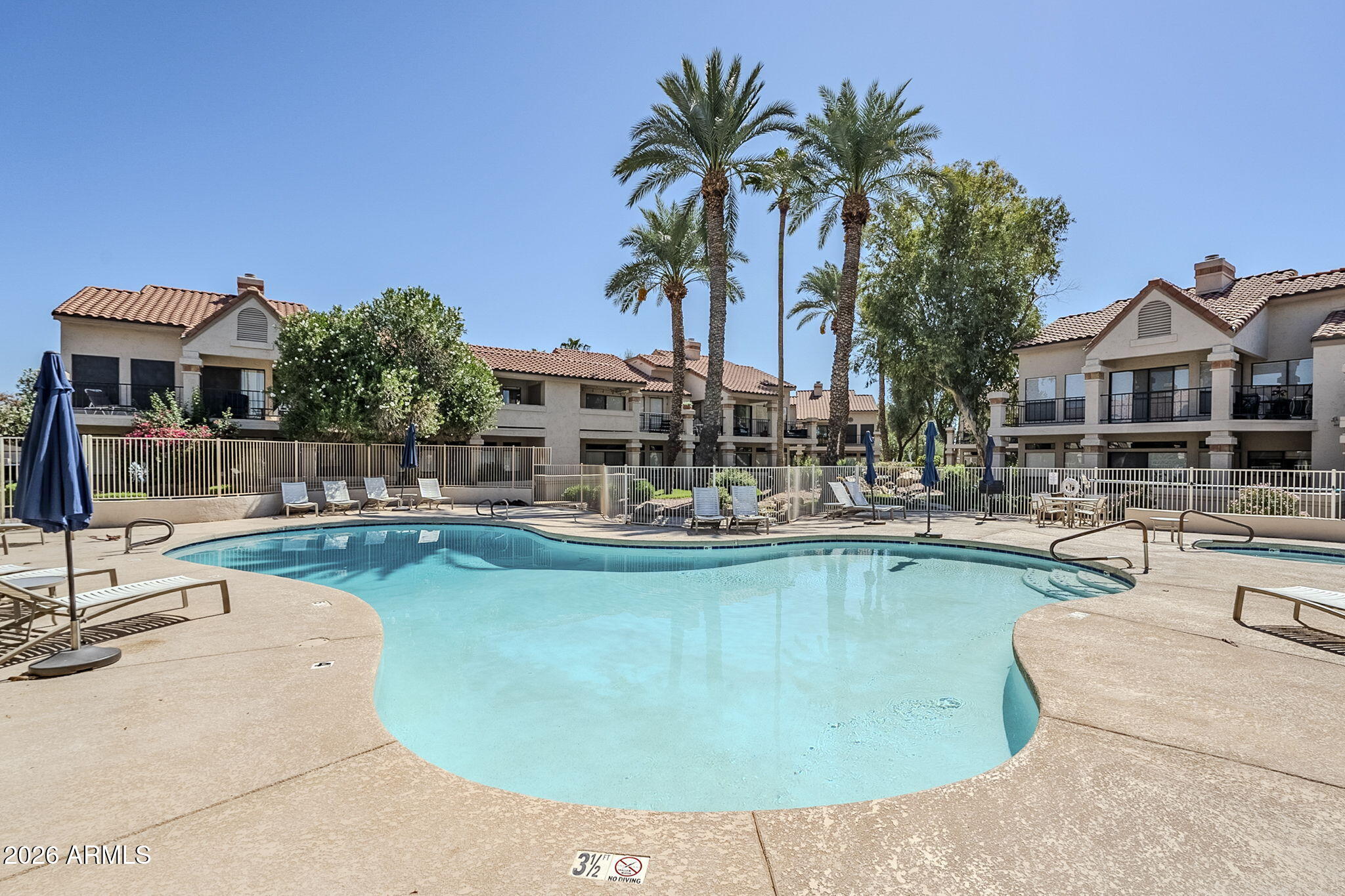 9707 East Mountain View Road, Unit 2412 Scottsdale, AZ 85258 - Photo 46 of 61 a view of a swimming pool with chairs