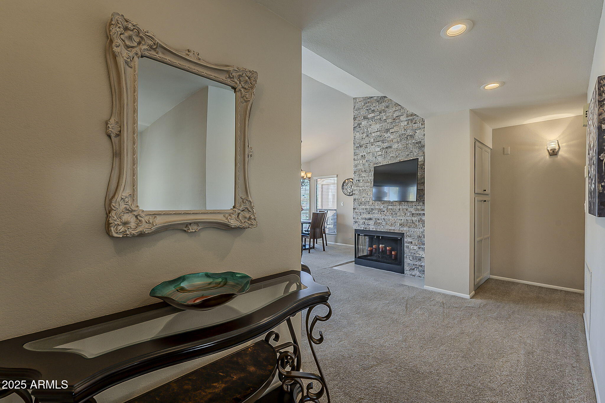9707 East Mountain View Road, Unit 2412 Scottsdale, AZ 85258 - Photo 5 of 43 a living room with furniture and a fireplace
