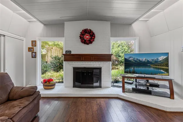 a living room with furniture fireplace and flat screen tv